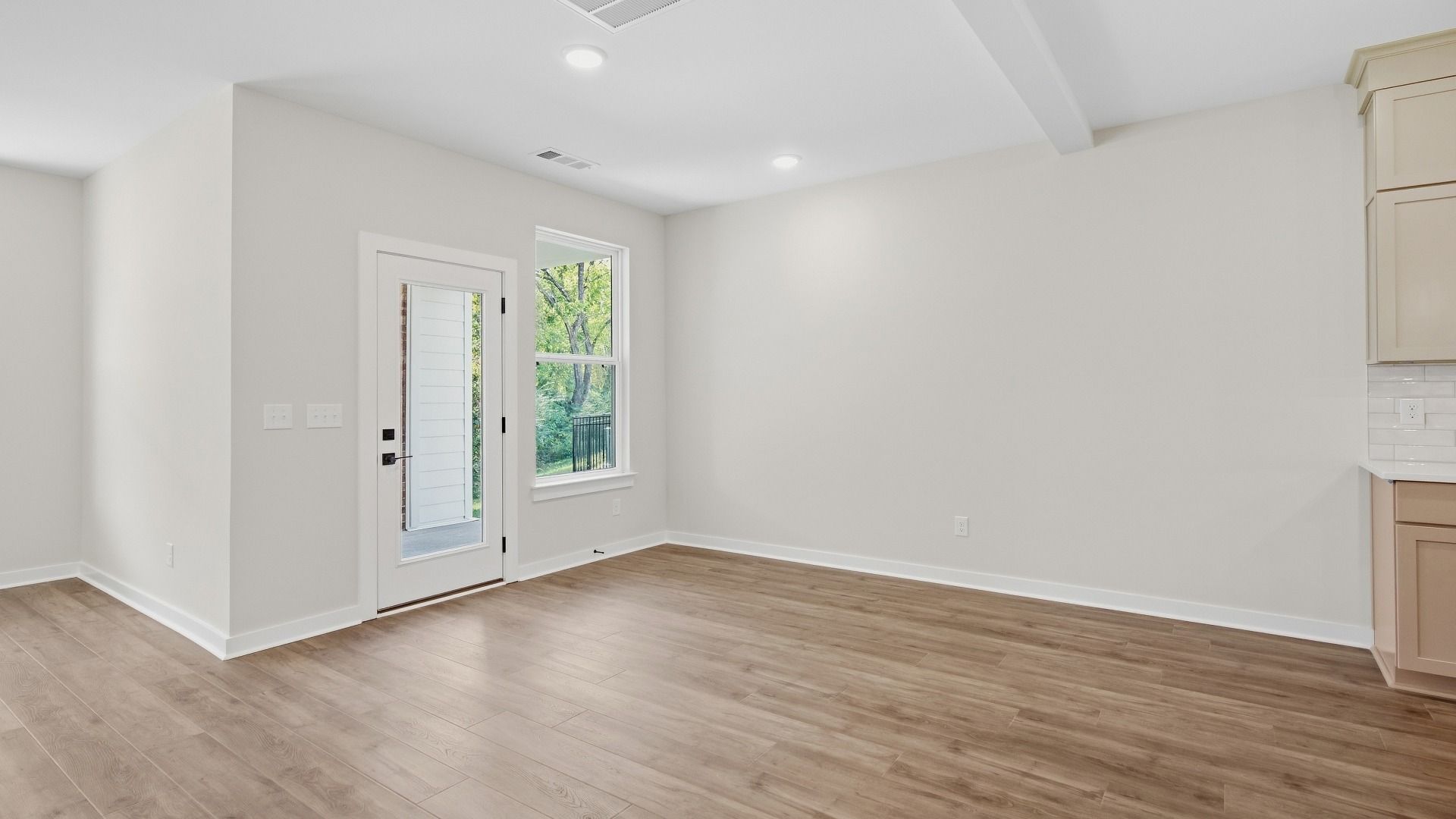 Backyard door next to kitchen and other living spaces