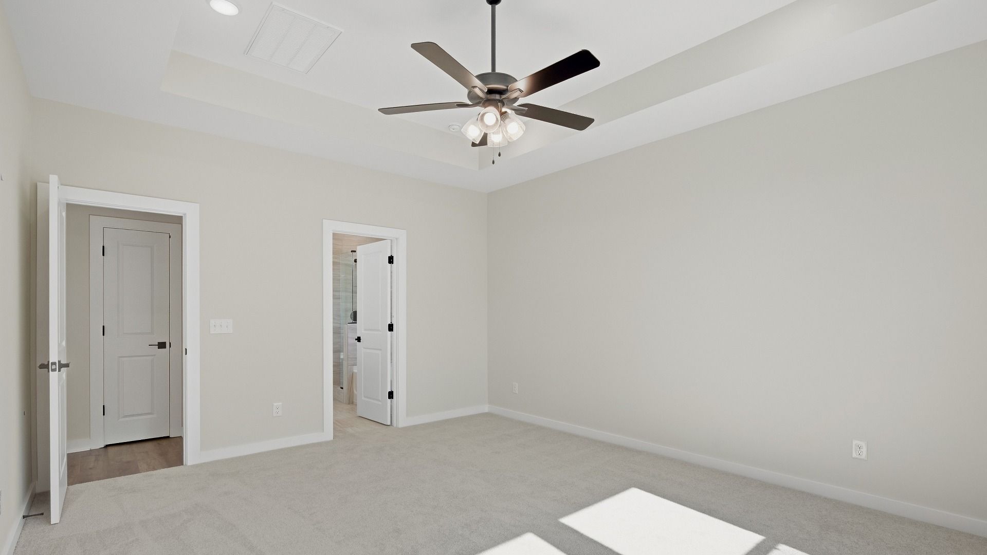 Primary bedroom with connected luxury bathroom and walk-in closet