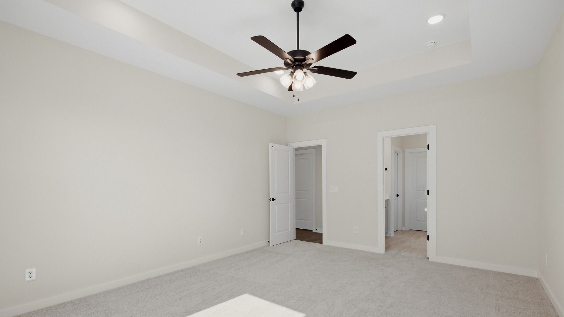 Primary bedroom with connected luxury bathroom and walk-in closet