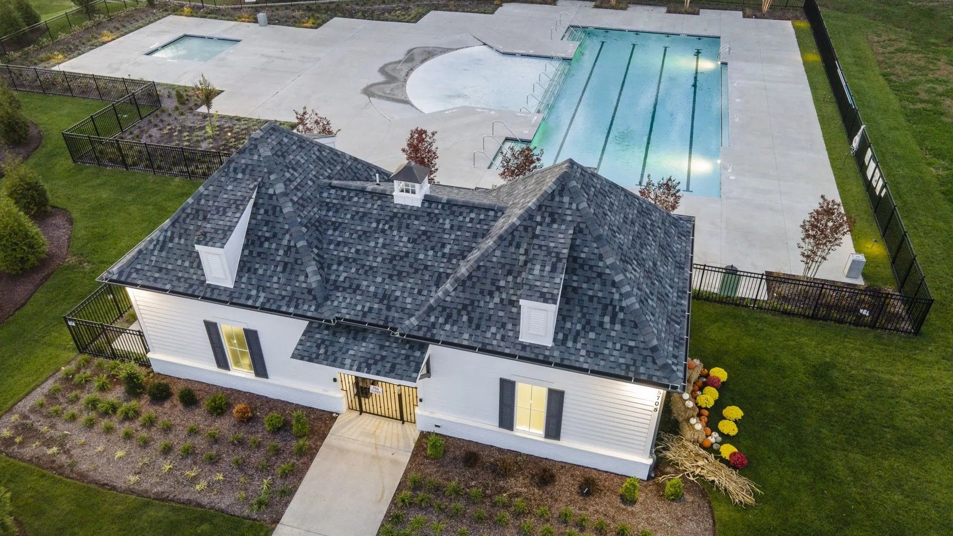 Large community pool with nighttime lighting