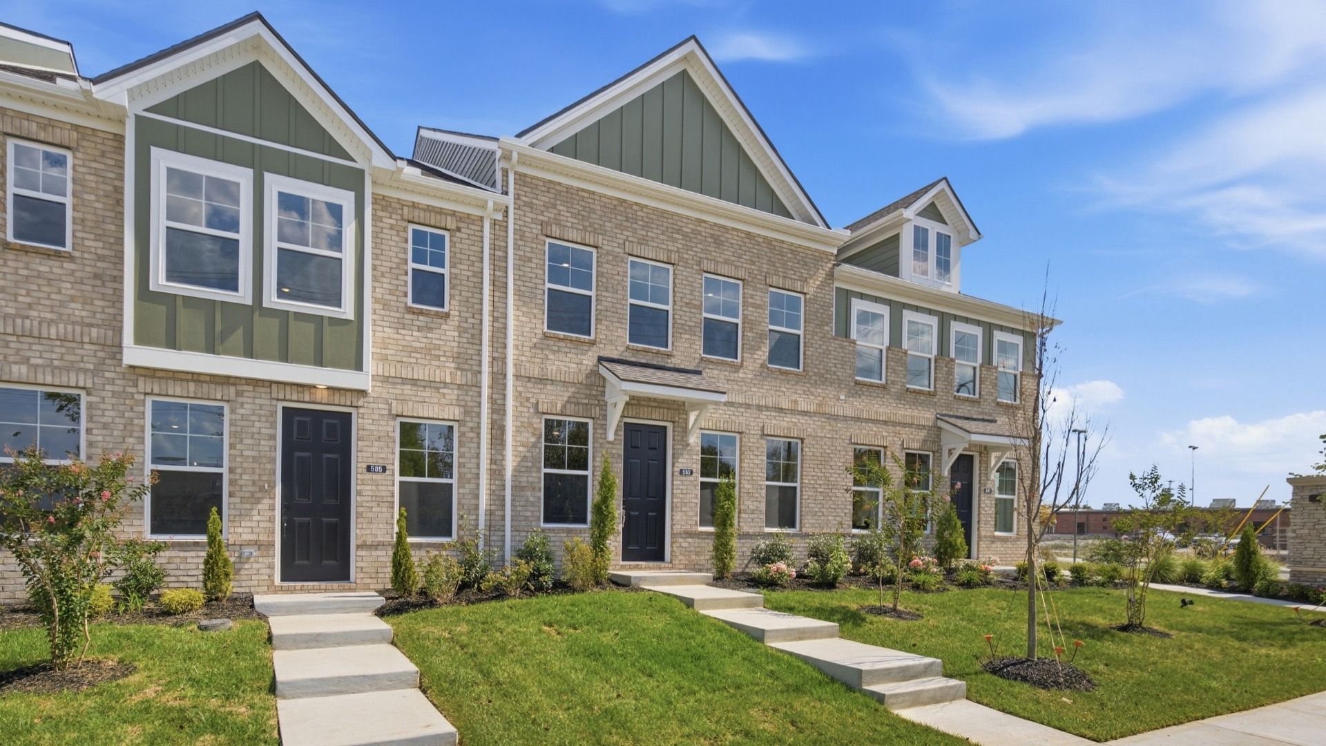 Beautiful two-story townhome with green accents and black door