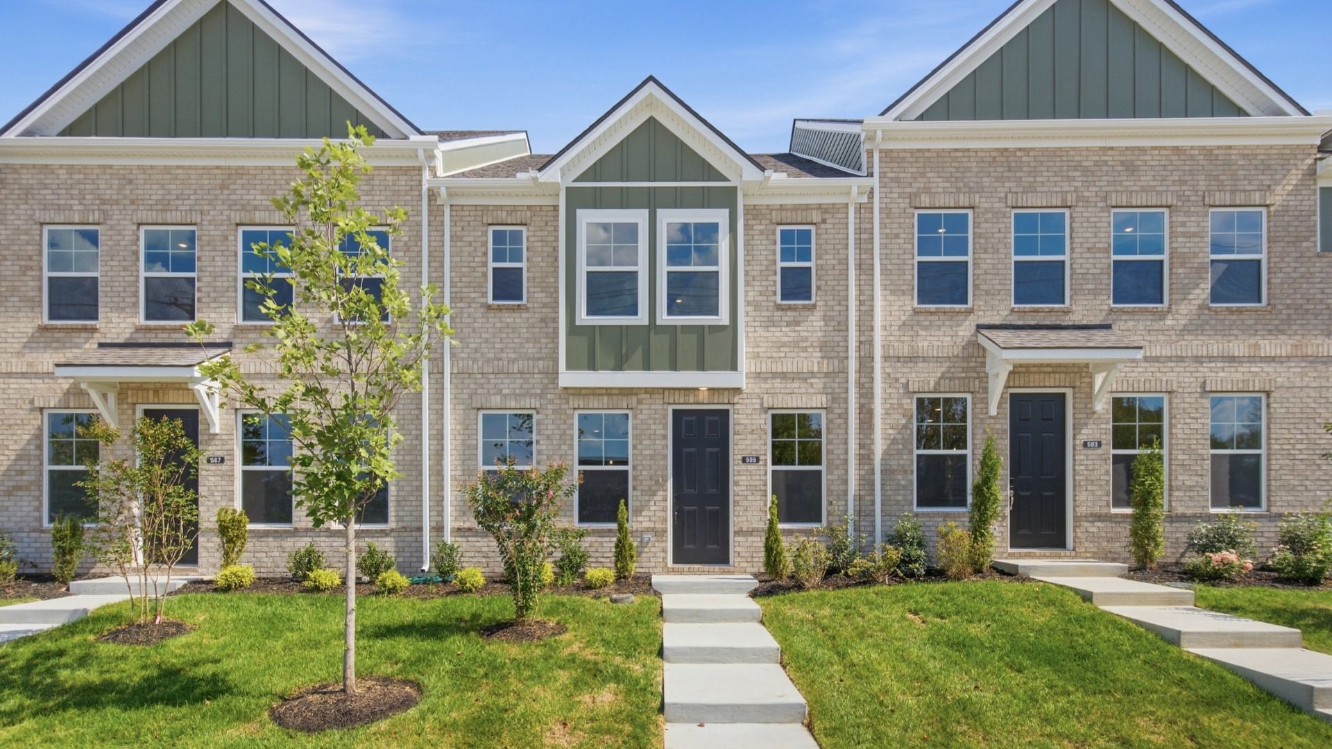 Beautiful two-story townhome with green accents and black door in Lebanon, Tennessee