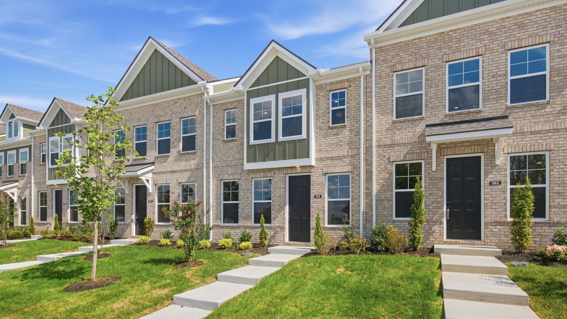 Beautiful two-story townhome with green accents and black door in Lebanon, Tennessee