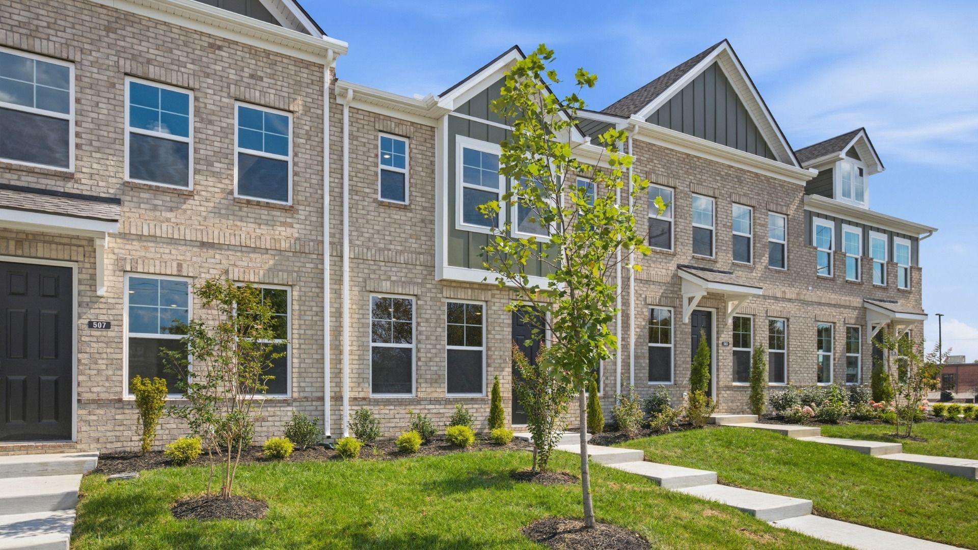 Beautiful two-story townhome with green accents and black door in Lebanon, Tennessee