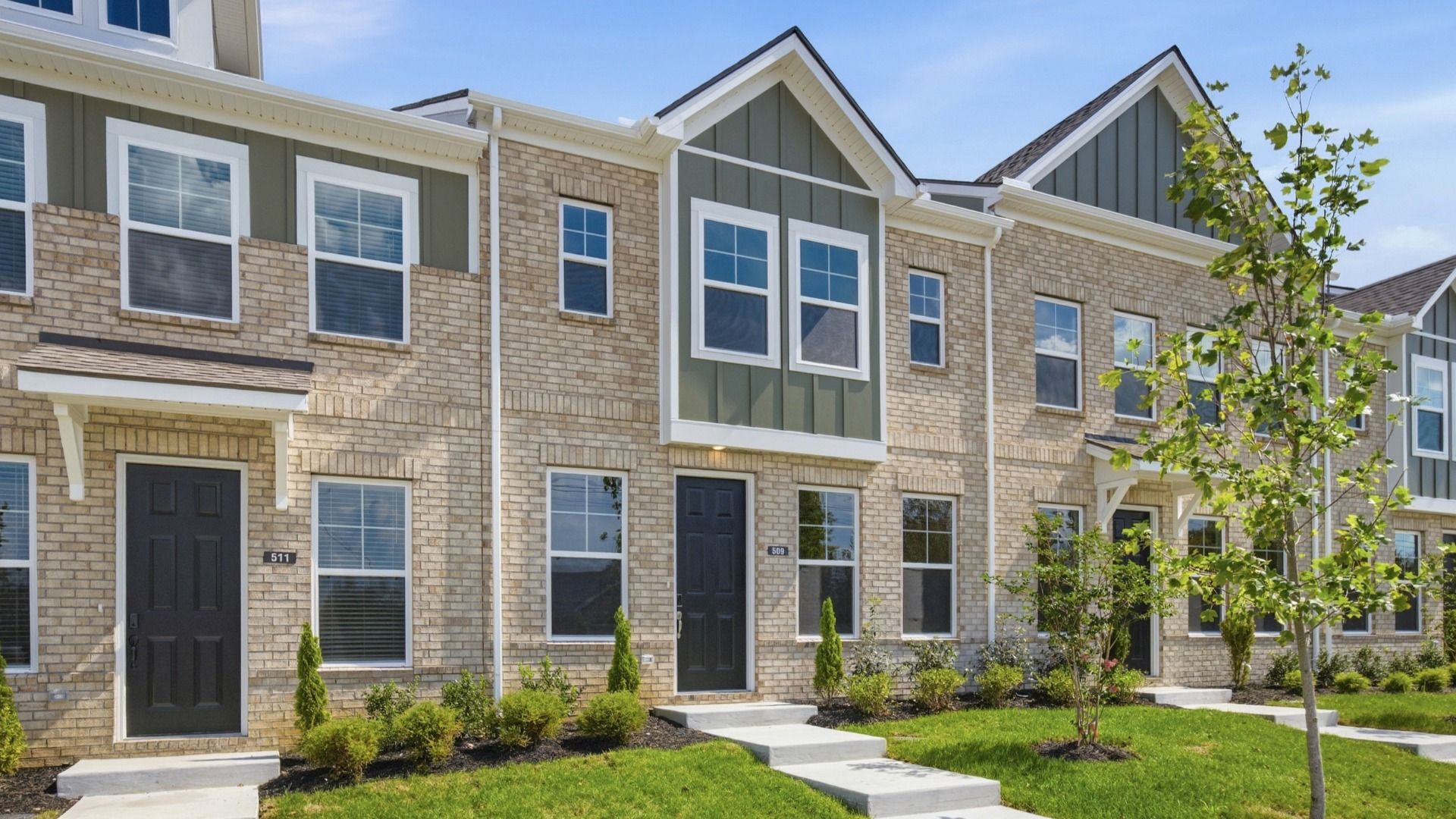 Beautiful two-story townhome with green accents and black door in Lebanon, Tennessee