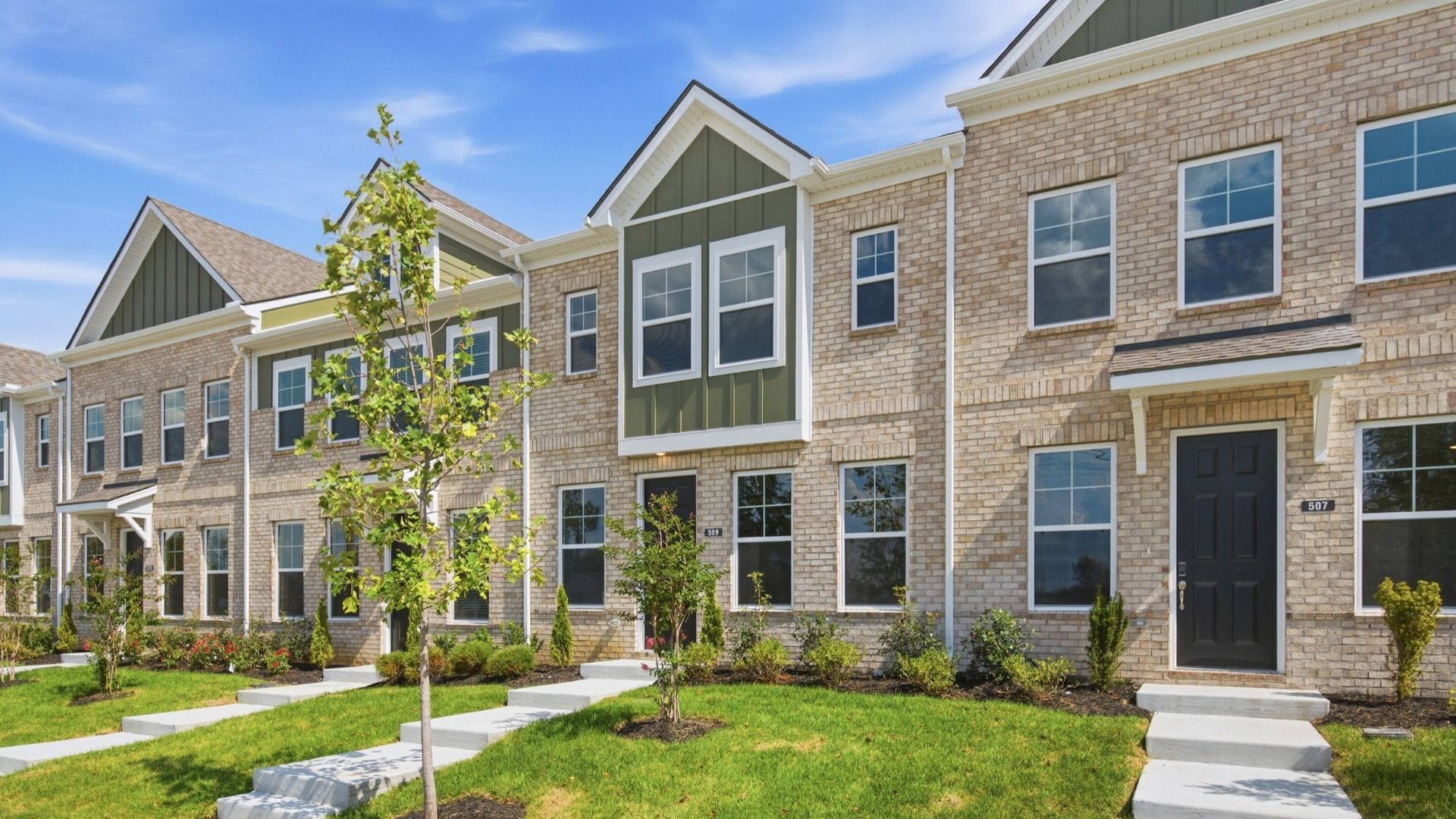 Beautiful two-story townhome with green accents and black door in Lebanon, Tennessee
