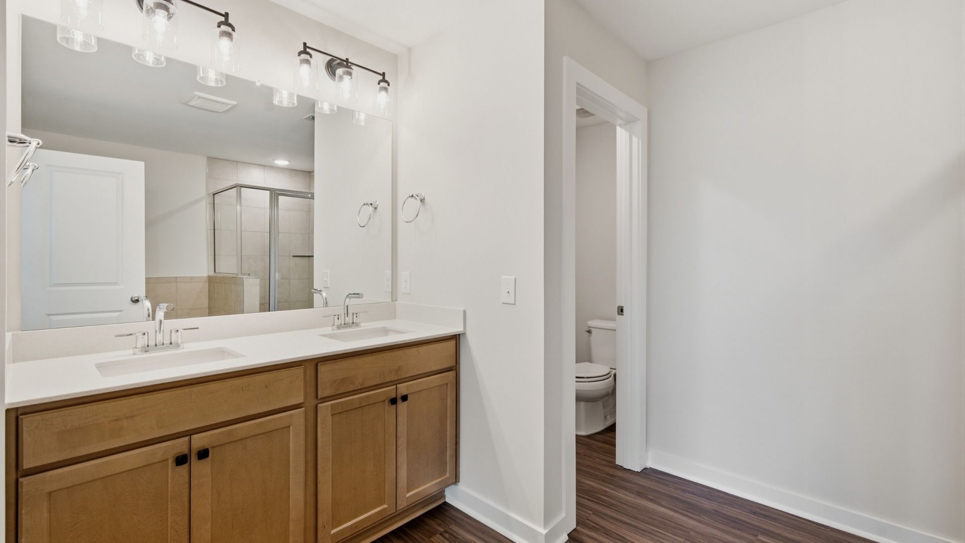 Water closet next to dual sinks