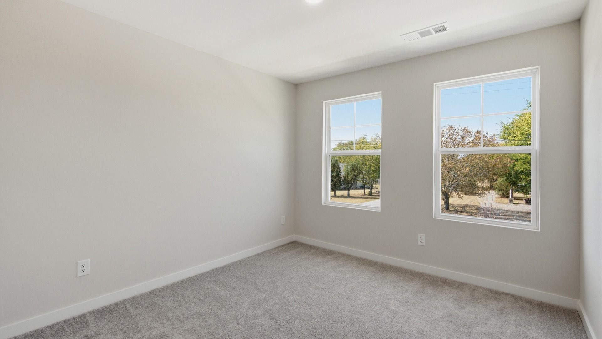 Secondary bedroom with upstairs view of community