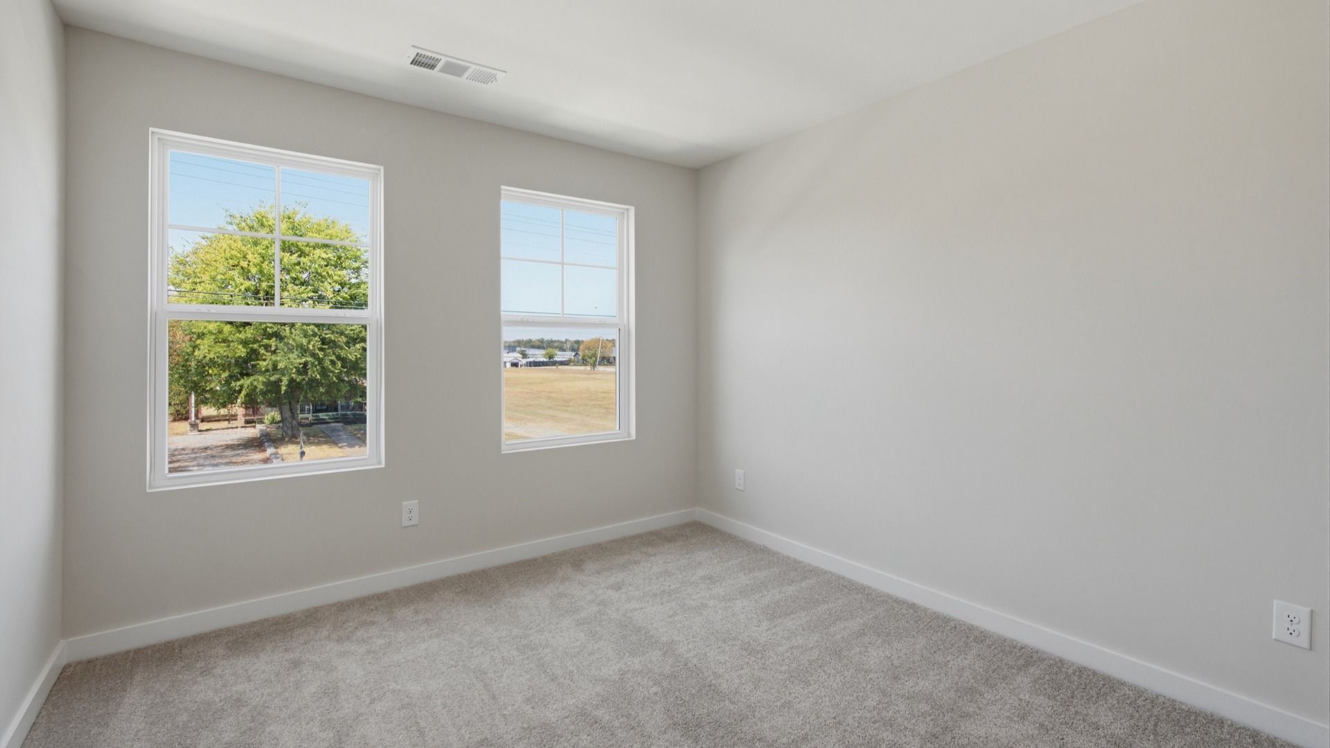 Secondary bedroom with upstairs view of community