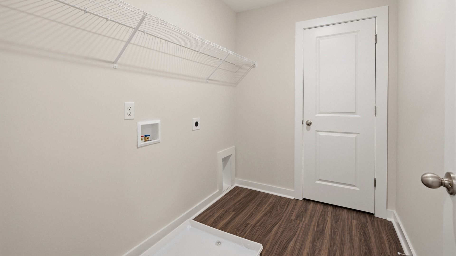Dedicated laundry room with rack above for storage options