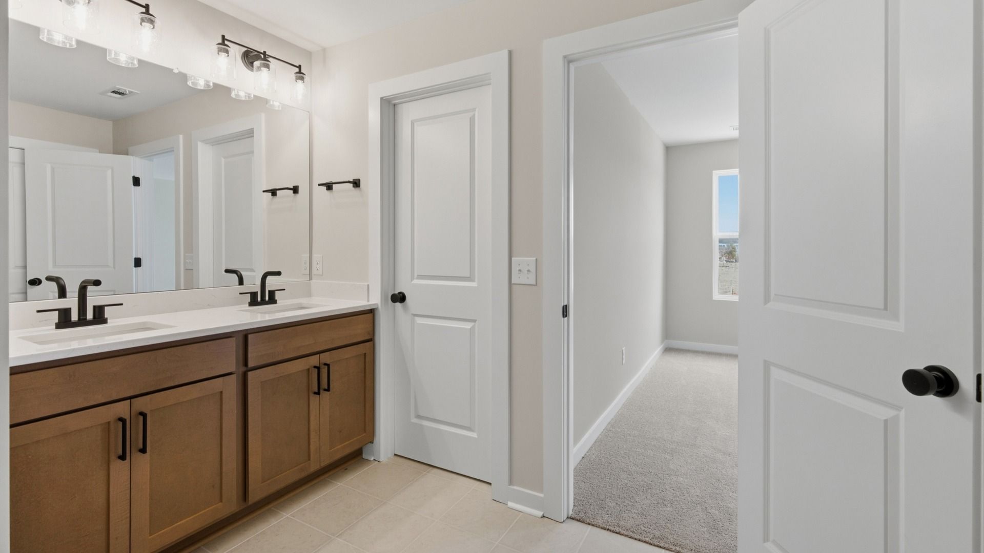 Primary bathroom with elevated features such as dual vanities