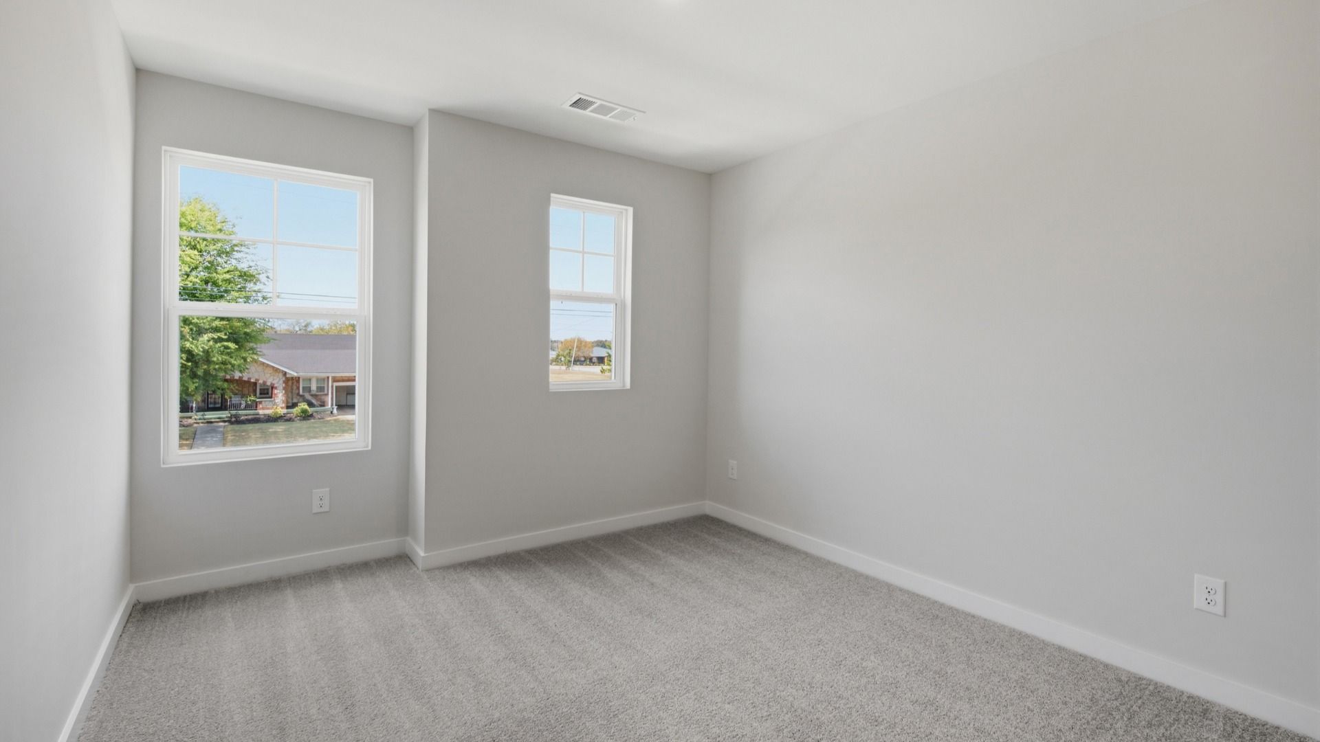 Secondary bedroom with upstairs view of community