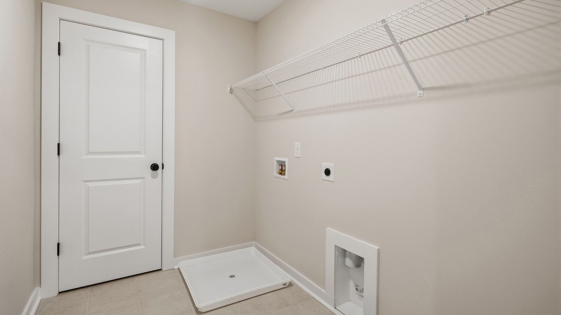 Dedicated laundry room with rack above for storage options