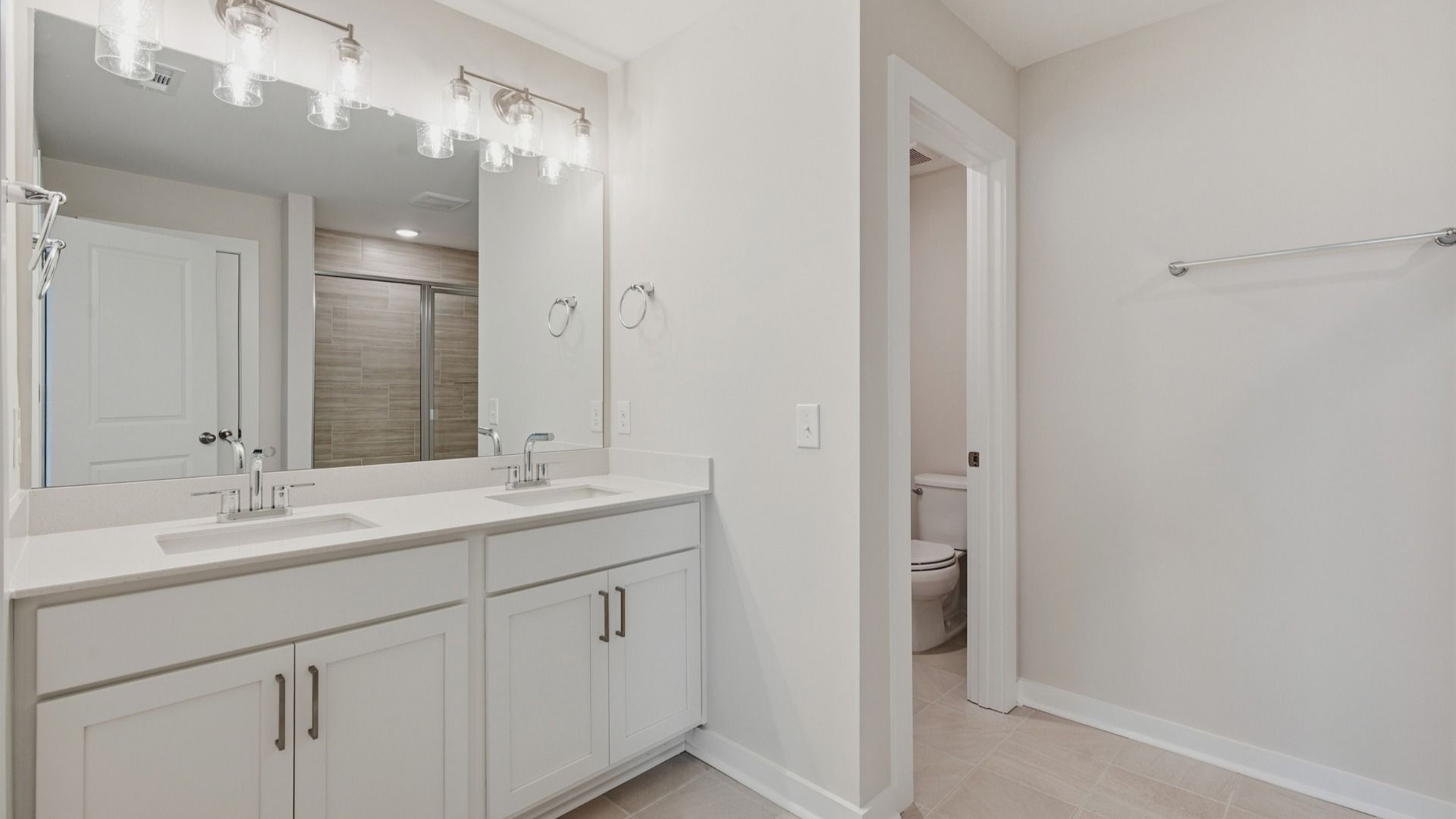Primary bathroom with elevated features such as dual vanities