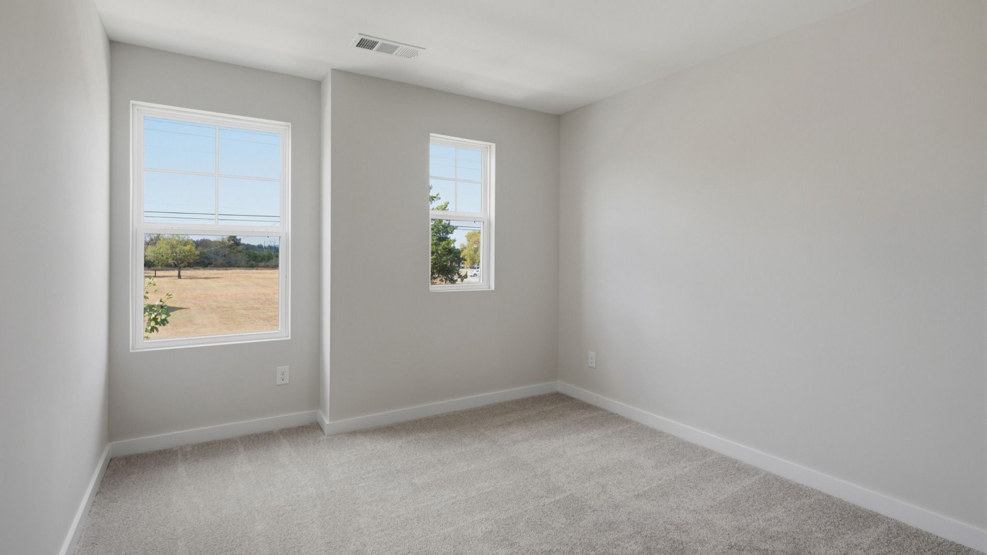 Secondary bedroom with upstairs view of community