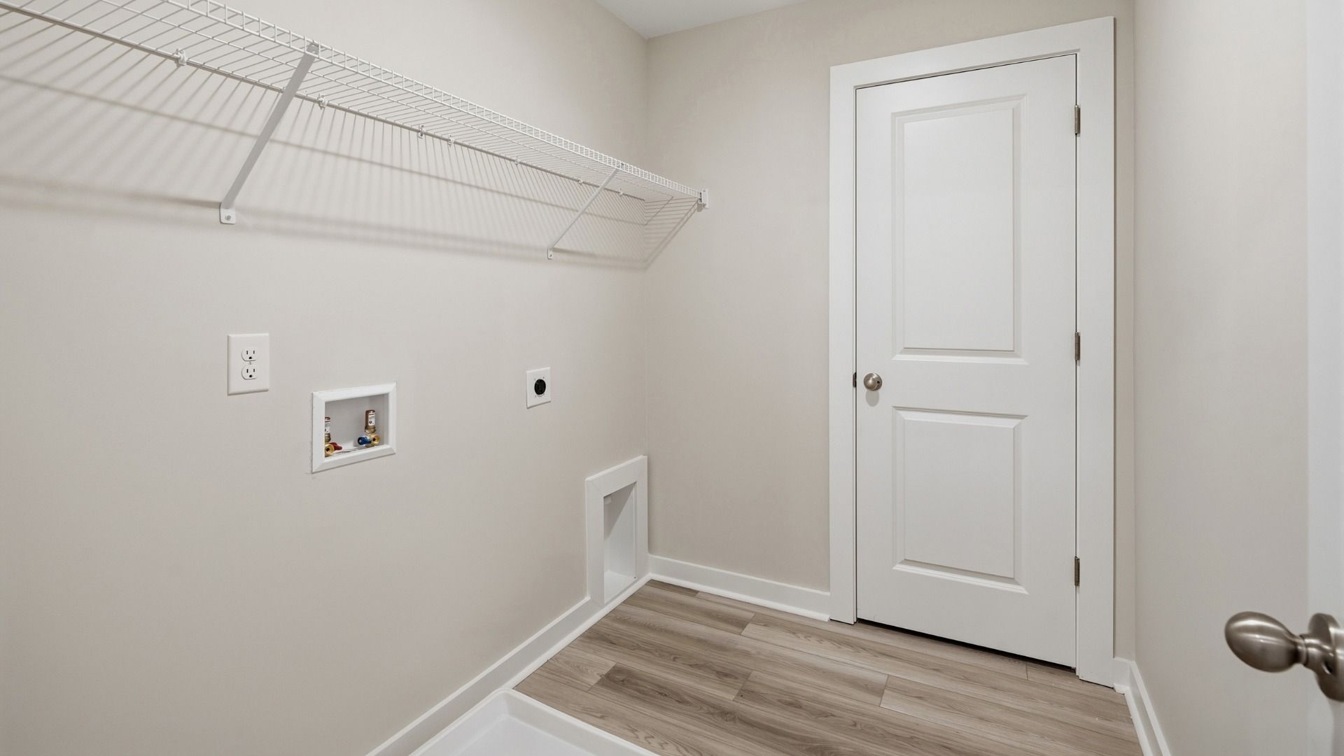Dedicated laundry room with rack above for storage options