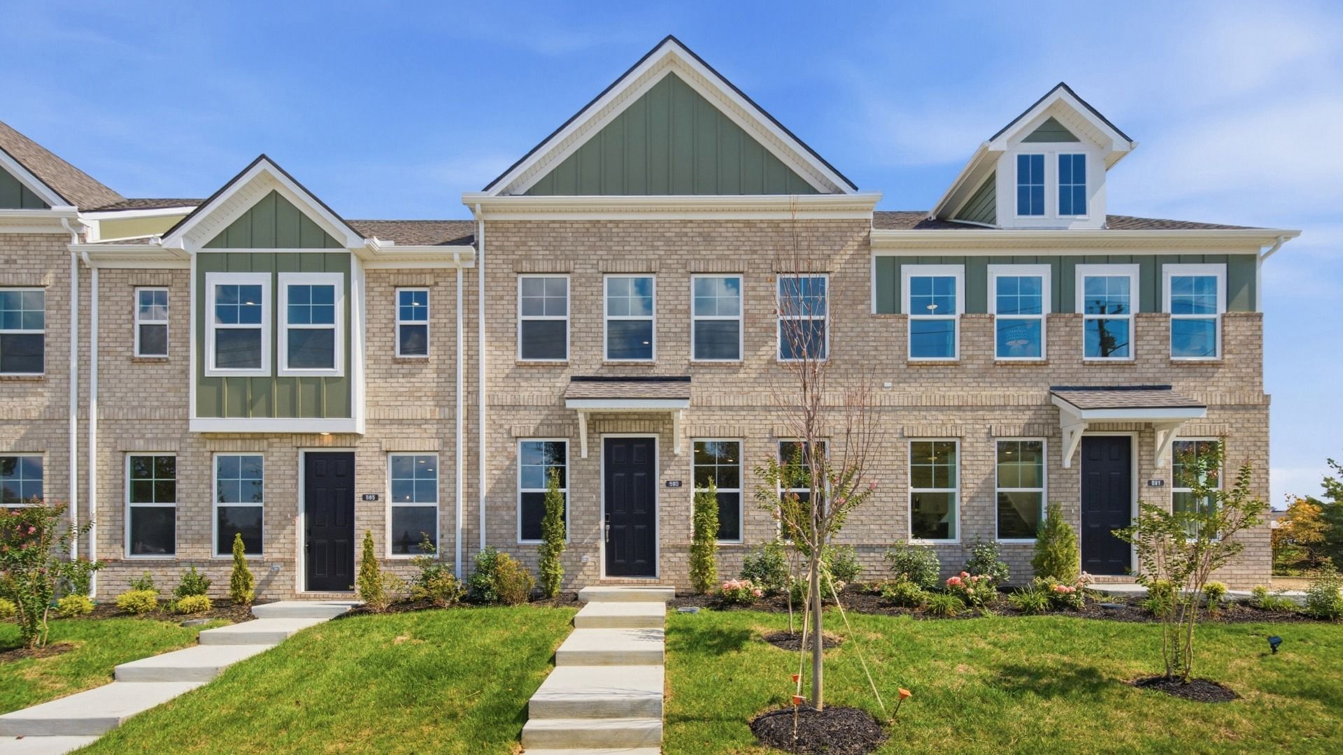 Front exterior with green accents of townhomes