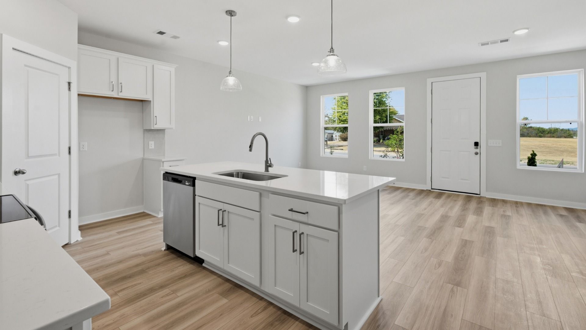 White kitchen island with sink and dishwasher