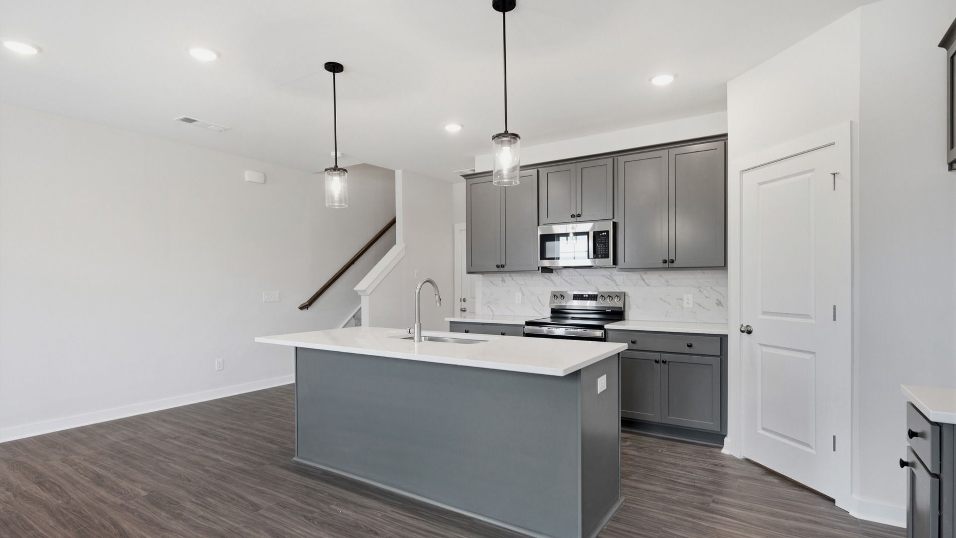 Kitchen with grey cabinets and elevated island