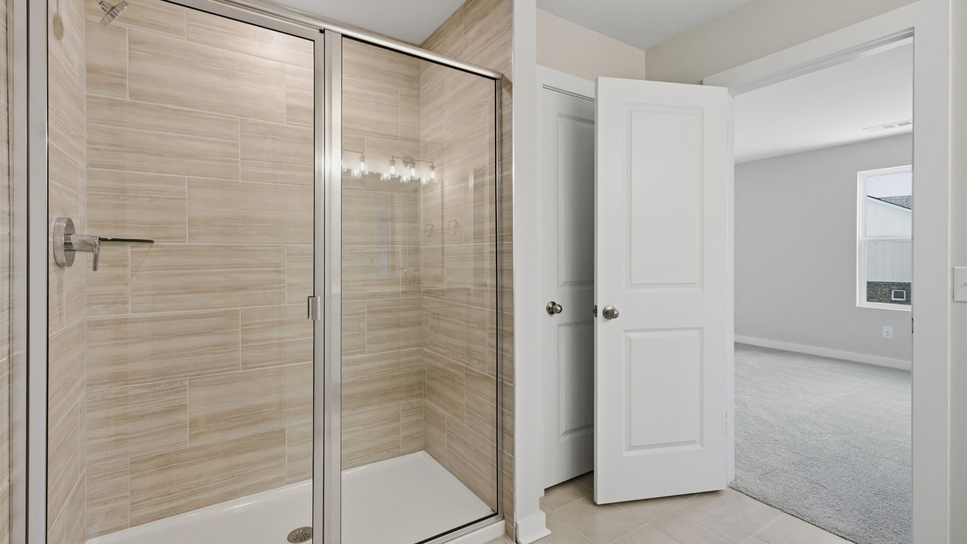 Primary bathroom connected to primary bedroom with larger shower