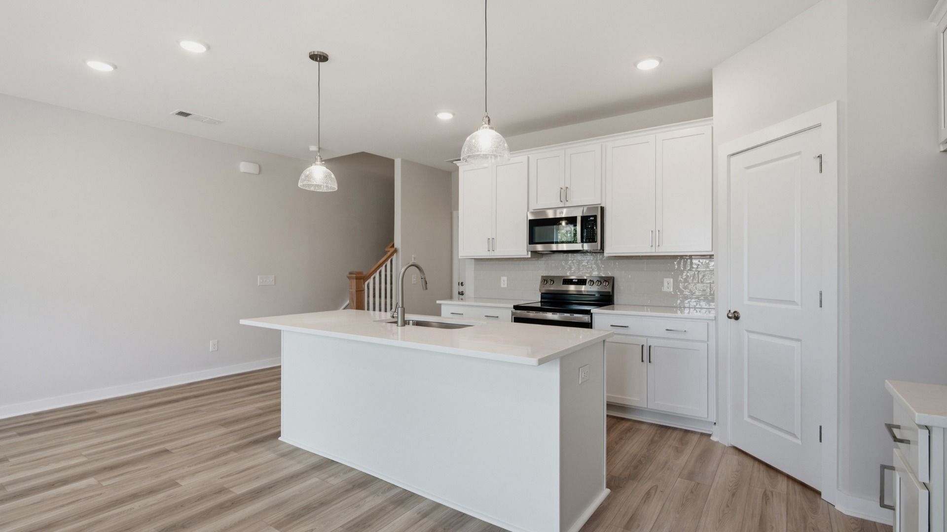 Kitchen with white cabinets and island