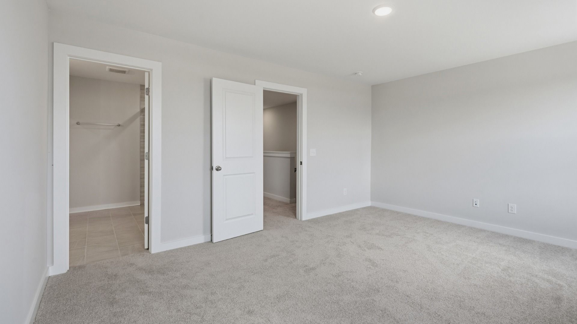 Primary bedroom with connected bathroom and walk-in shower
