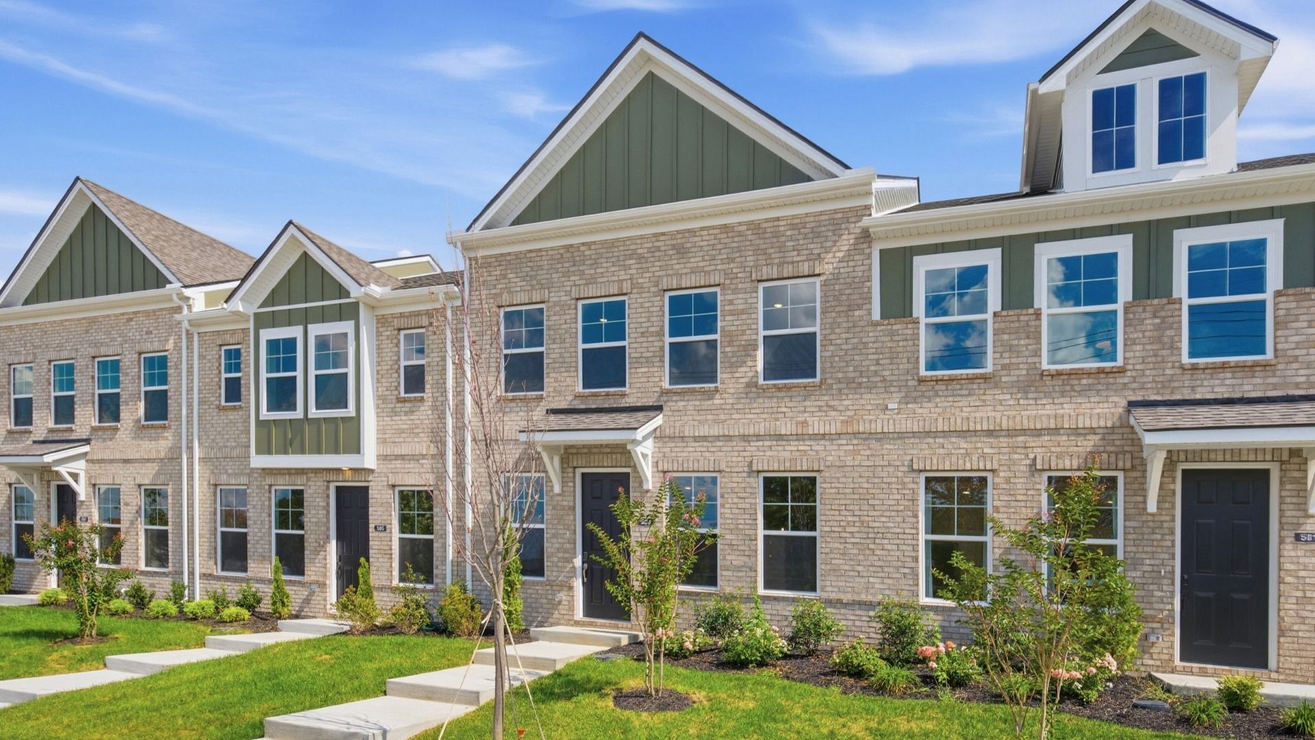The first townhome building at Hartmann Landing, showing off the Mountain Sage Color Scheme