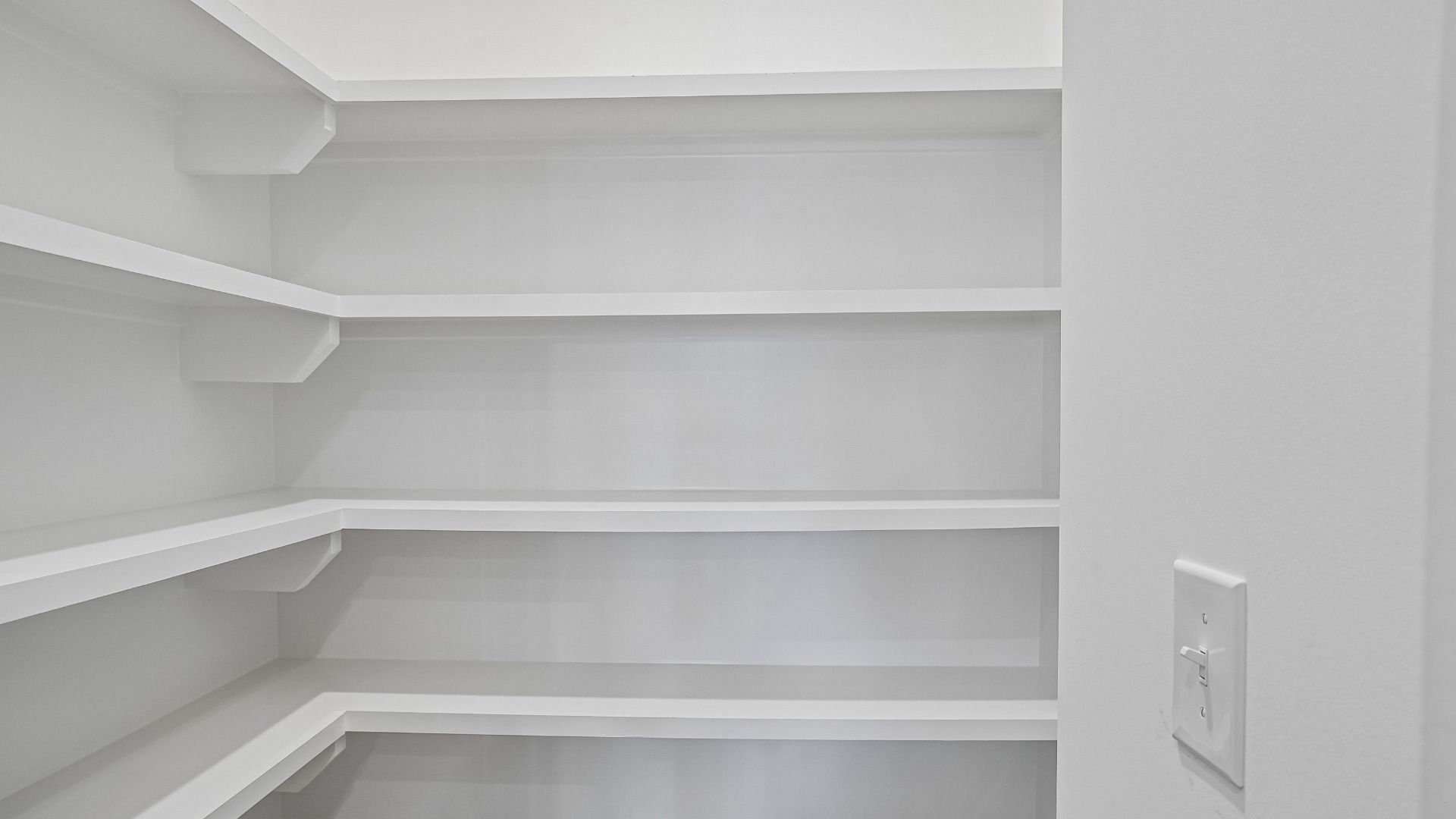 Spacious Walk-In Pantry with Upgraded Built-In Shelving Standard!