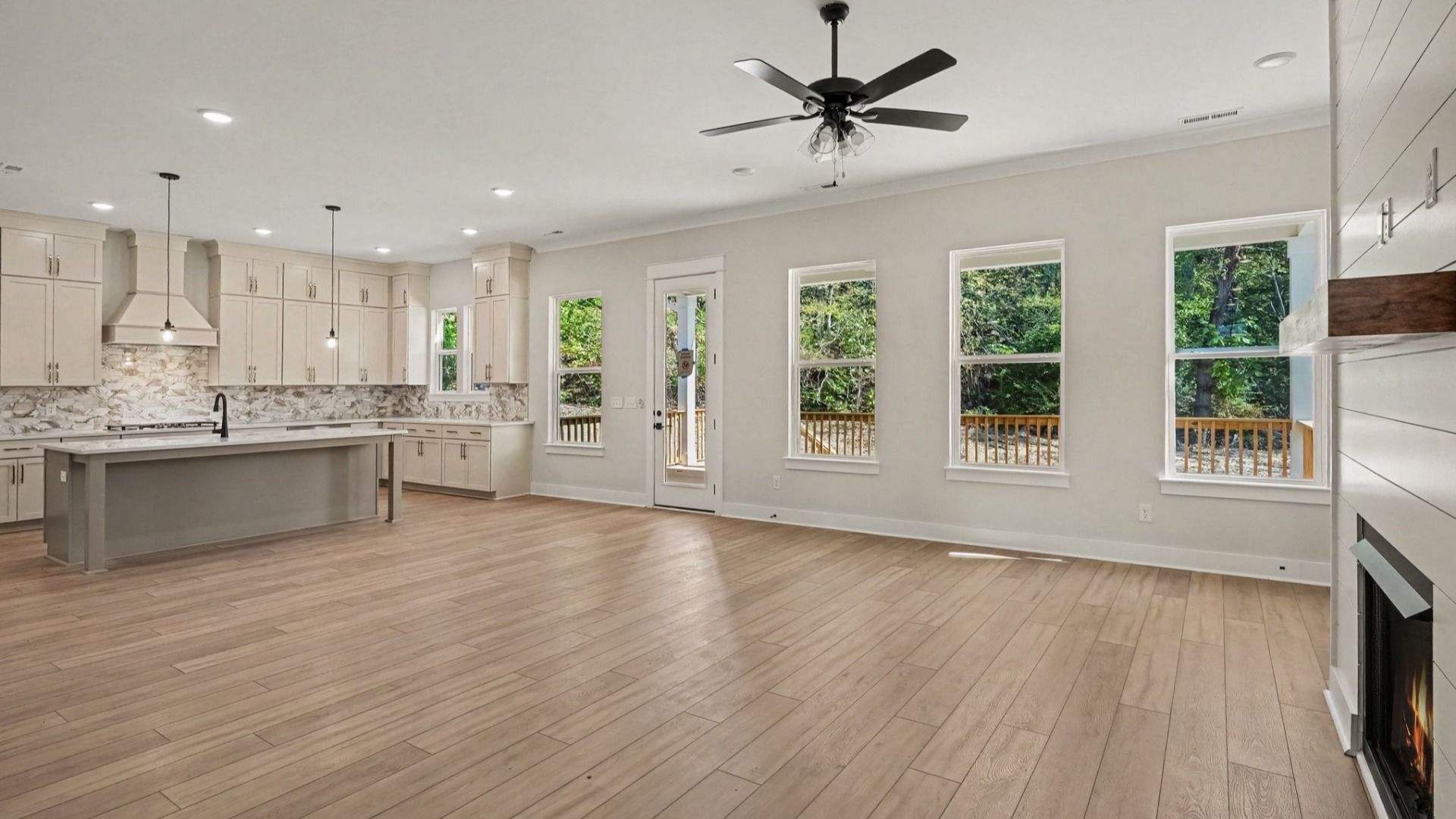 Open concept living area next to kitchen and dining areas