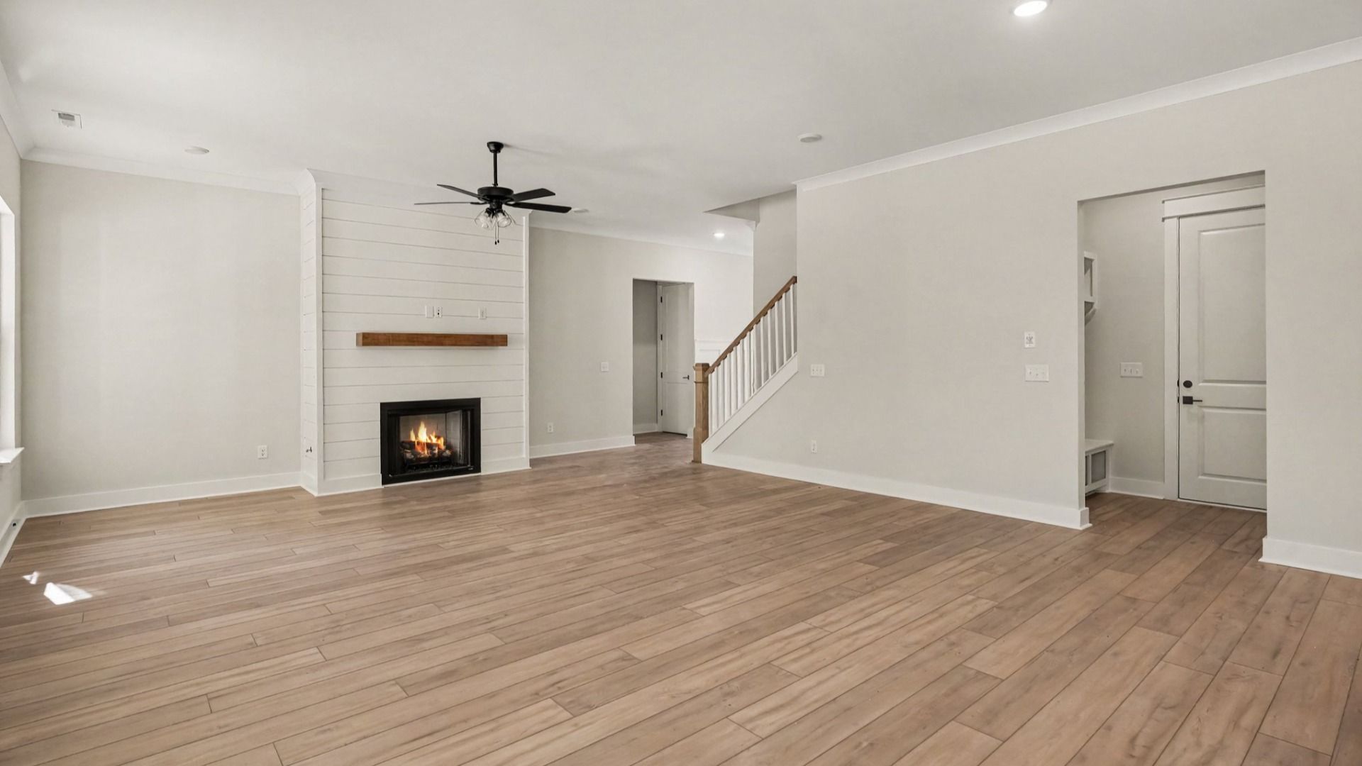Spacious living area next to staircase