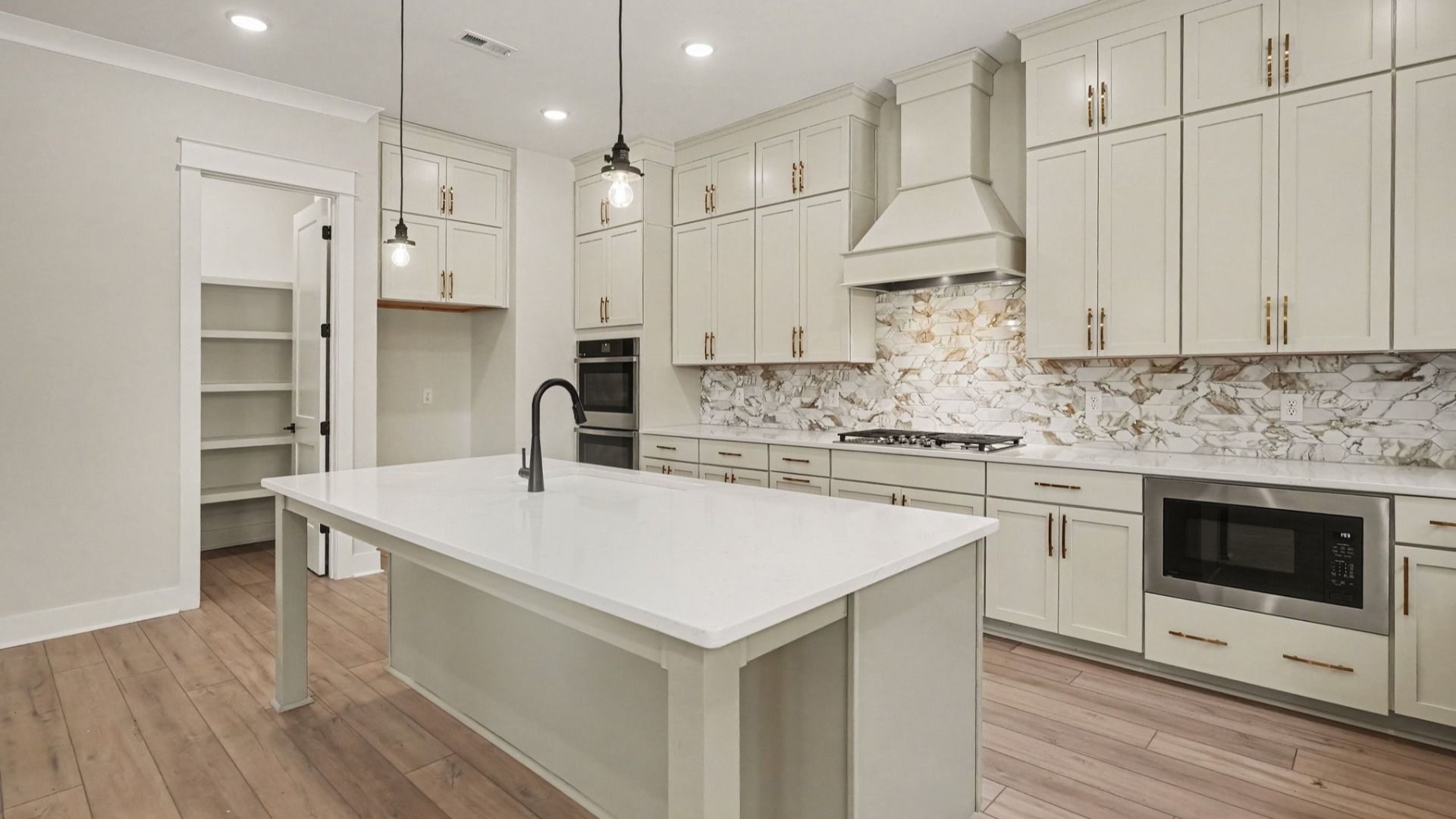 Elevated kitchen features in the Solace II home plan such as a gourmet kitchen with various cabinets and island
