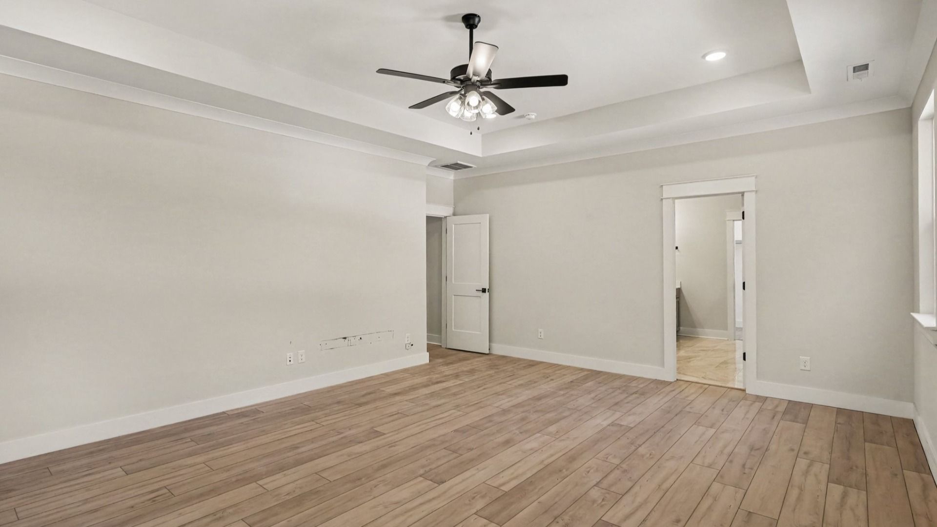 Primary bedroom with connected bathroom and walk-in closet