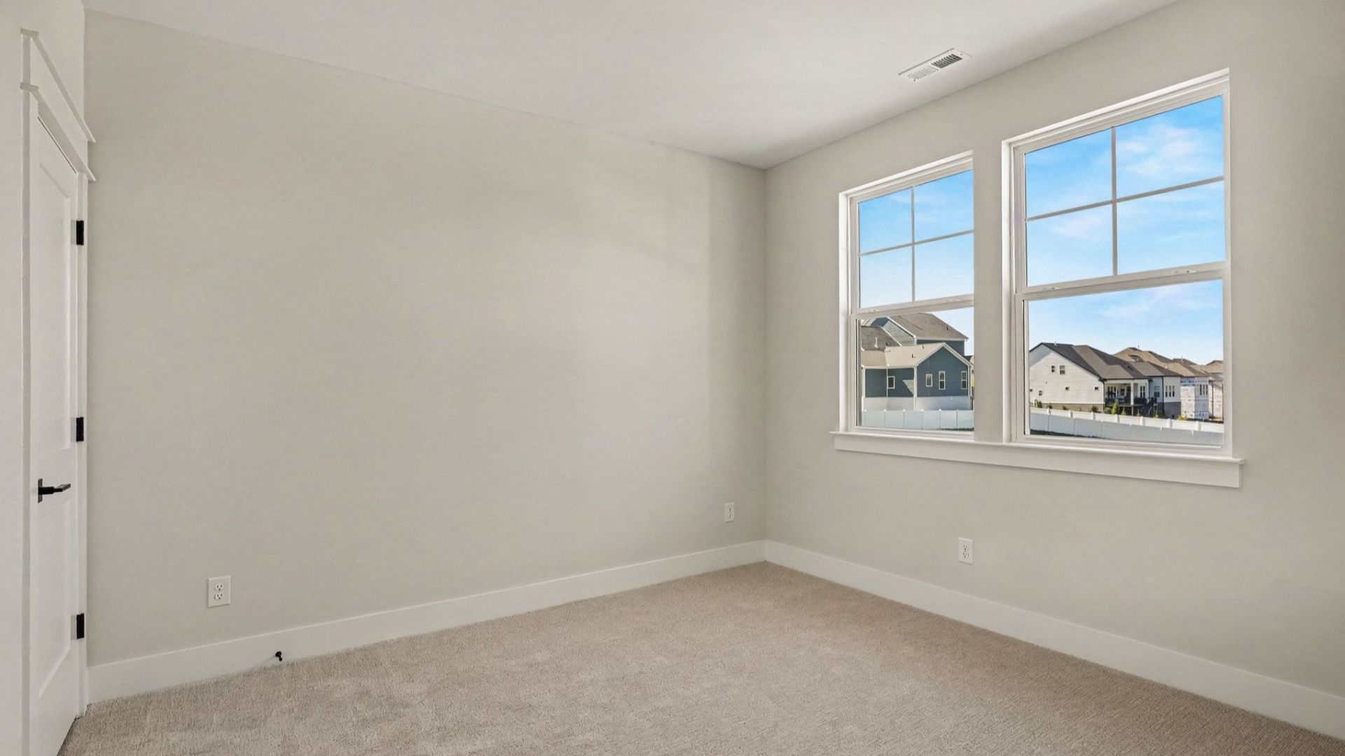Secondary bedroom with windows and closet