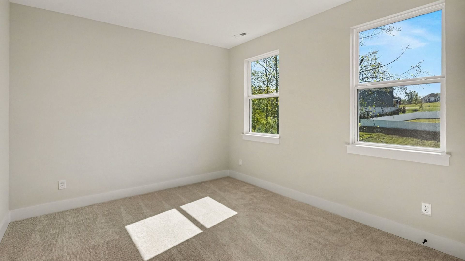 Secondary bedroom with windows and closet