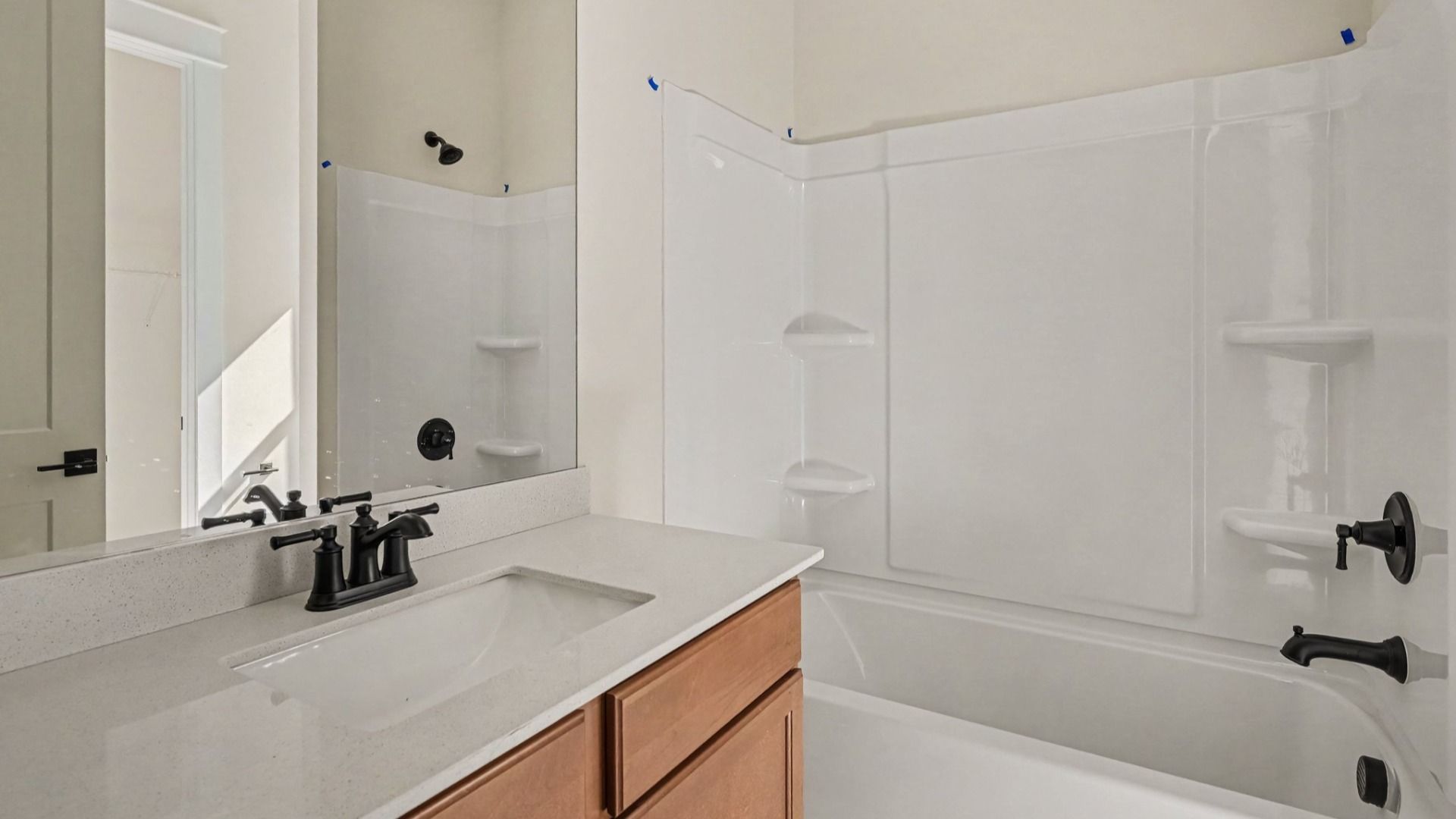 Bathroom with bathtub and dual vanities
