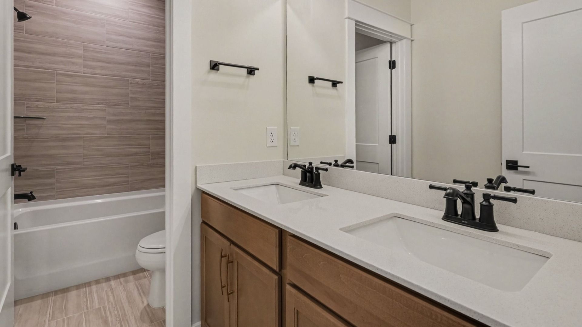 Bathroom with bathtub and dual vanities