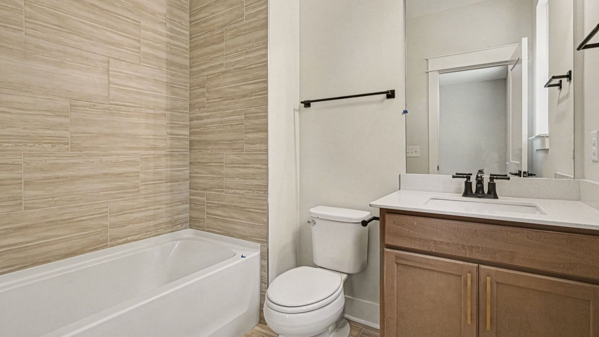 Bathroom with bathtub and dual vanities