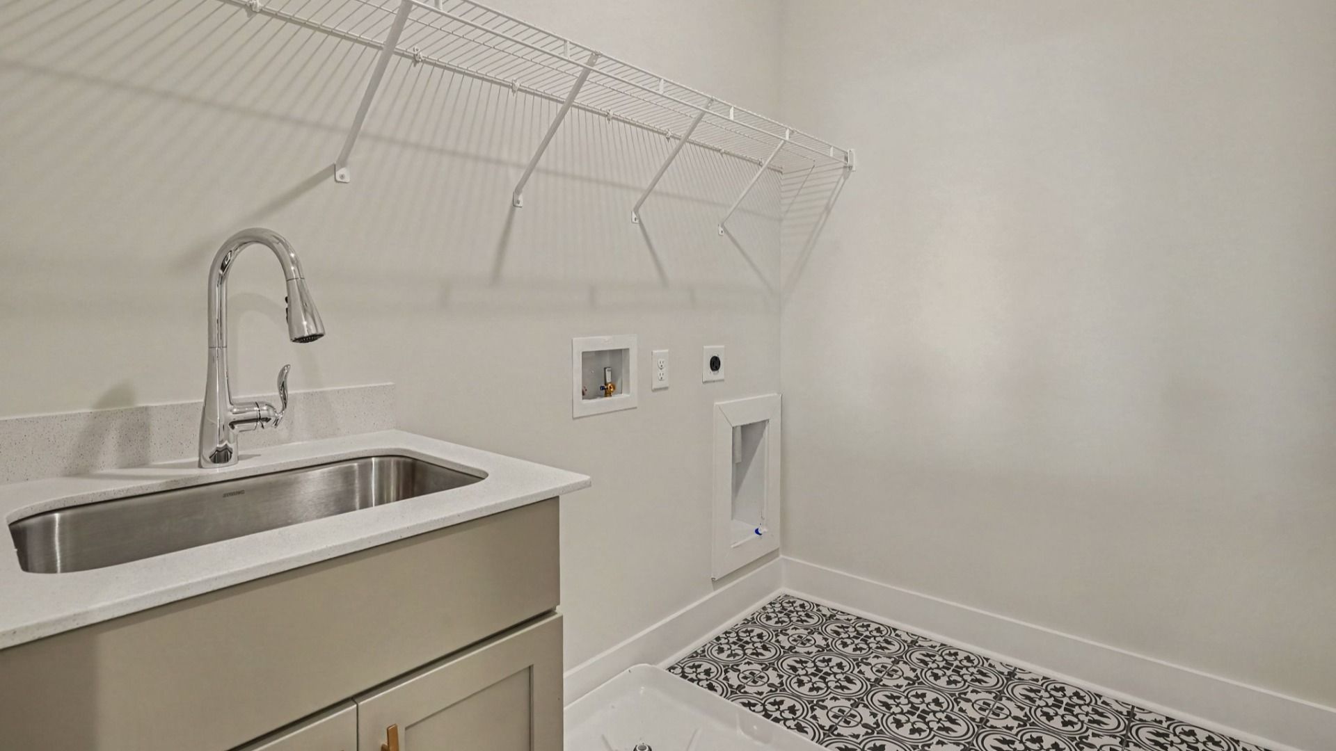 Dedicated laundry room with elevated floor tiling