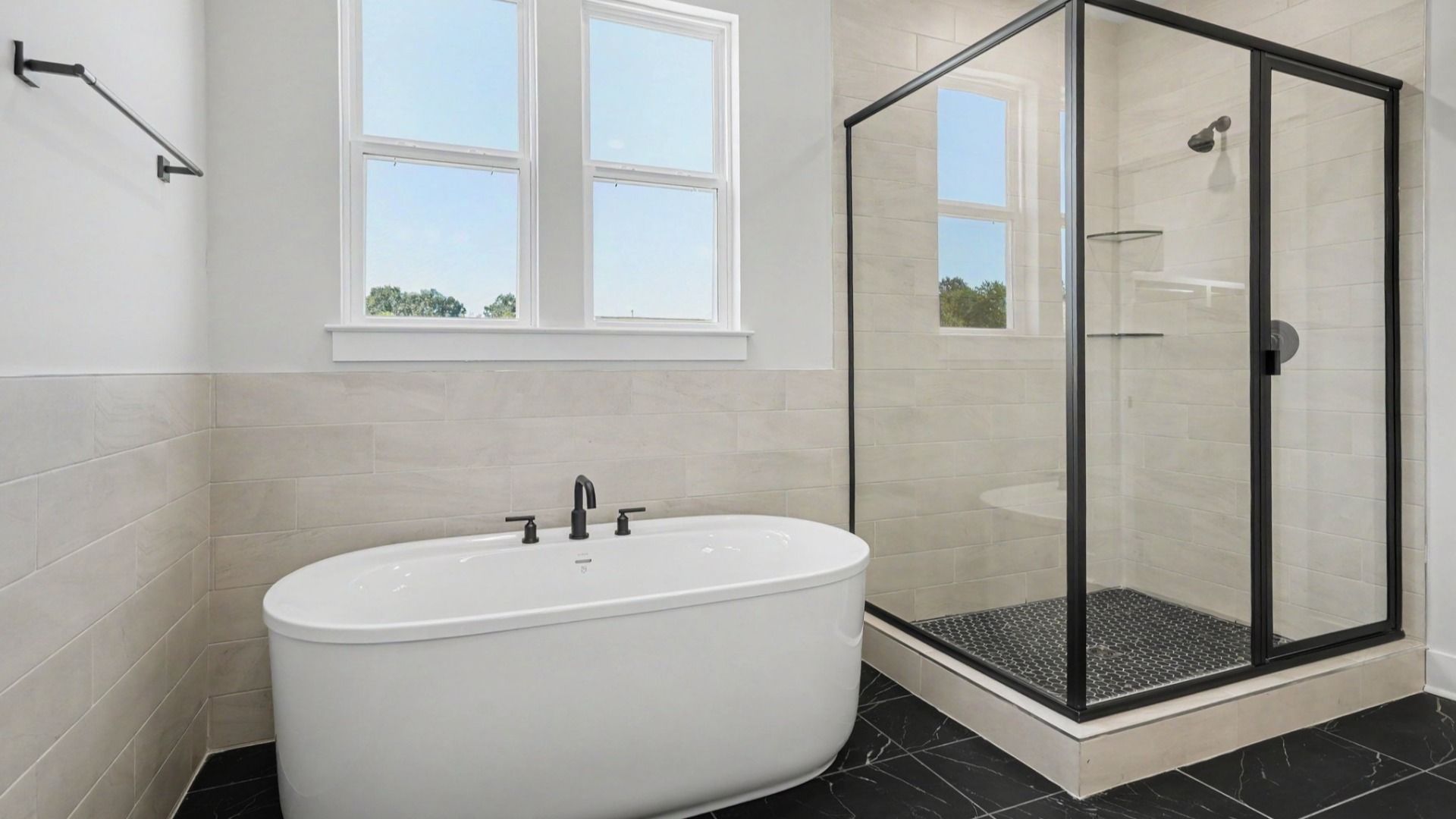 Bathtub next to shower in primary bathroom