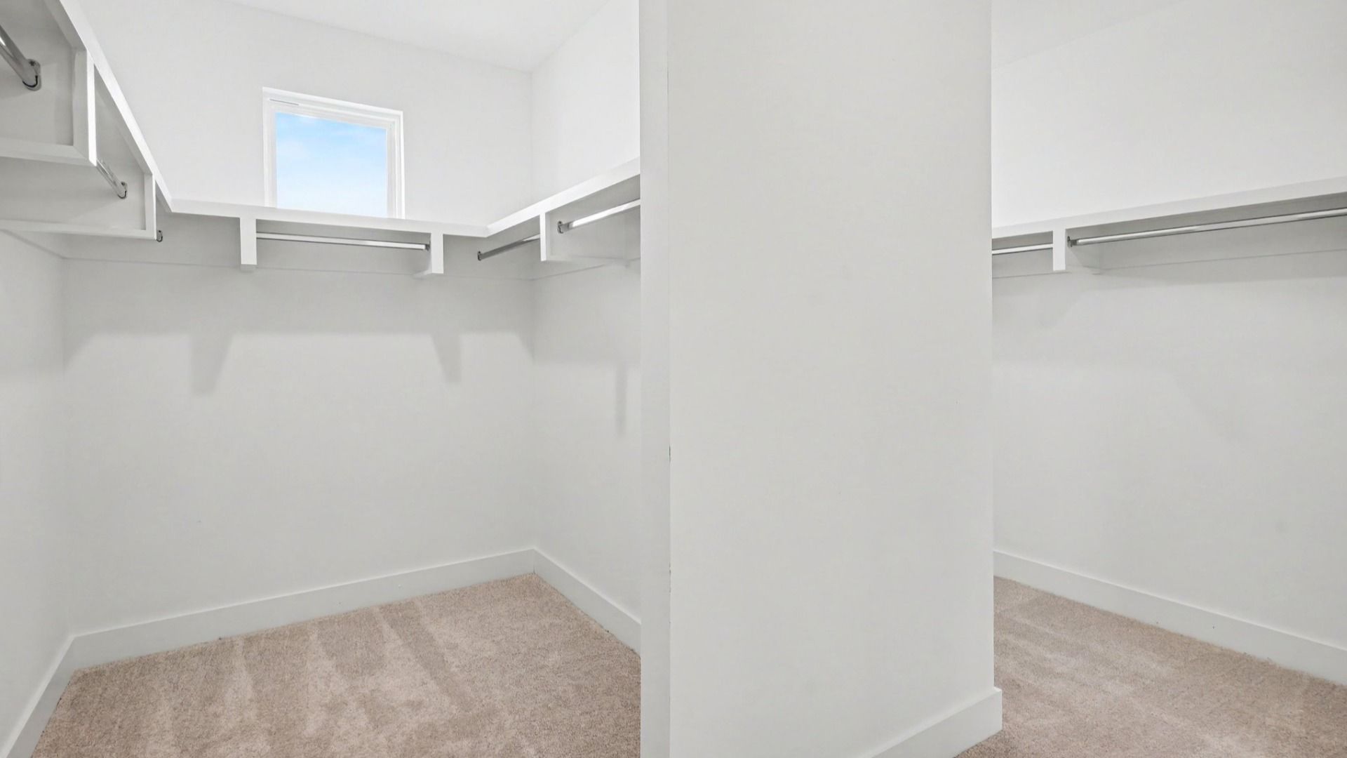 Spacious primary walk-in closet with two sides
