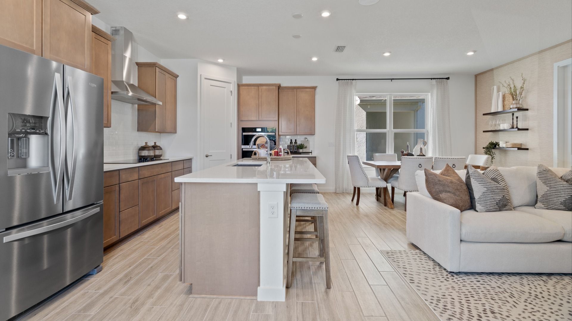 Open main floor kitchen, family room and cafe in a DRB Home Clementine model at the Trinity Place community.