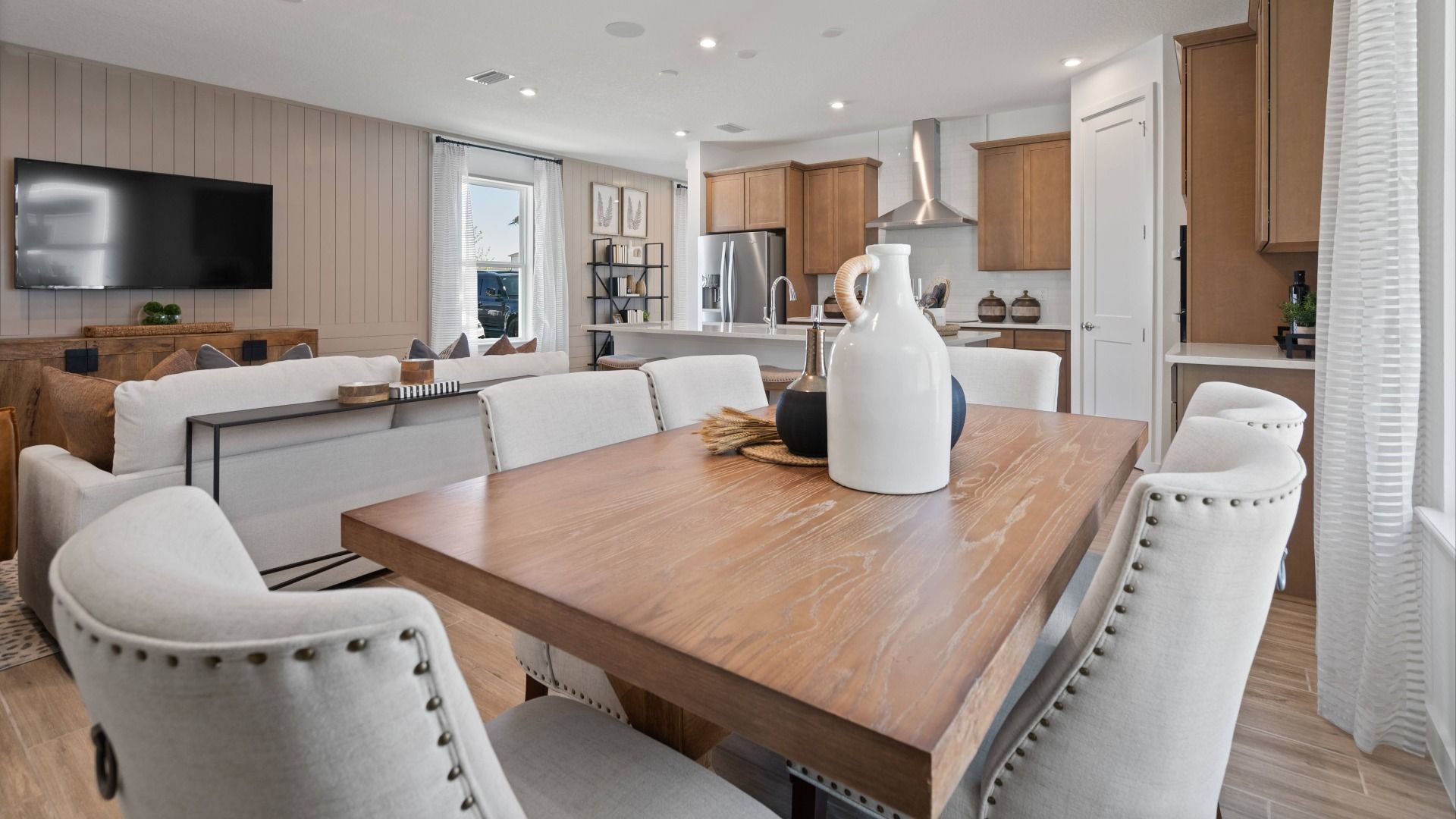 Open main floor cafe, family room and kitchen in a DRB Home Clementine model at the Trinity Place community.