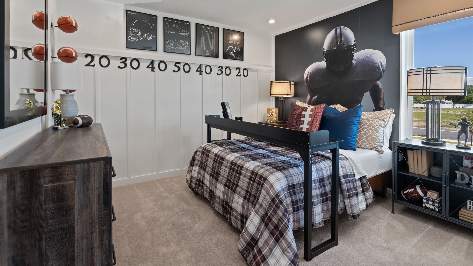 Carpeted secondary bedroom with large window in a DRB Home Clementine model at the Trinity Place community.