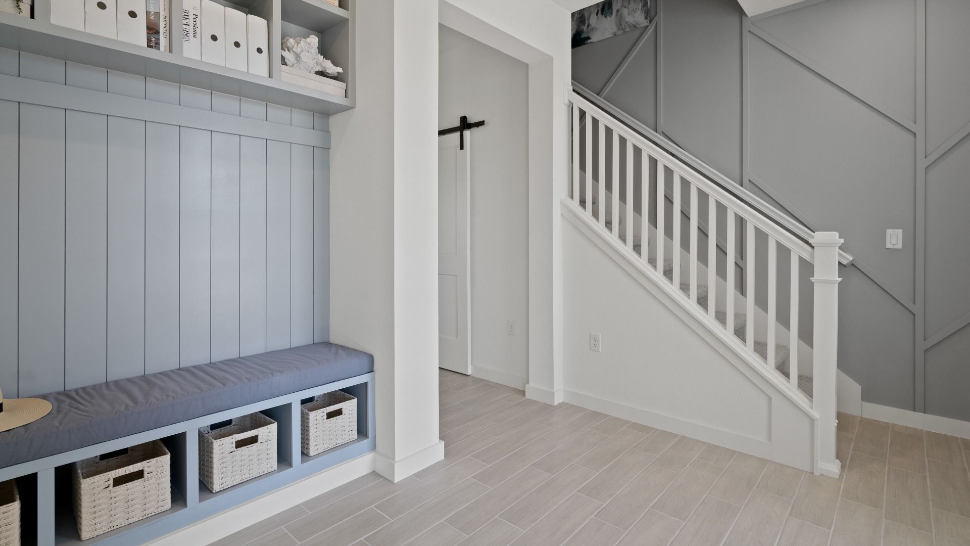 Front entry drop zone and stairs at a DRB Homes Ambersweet model at the Trinity Place community.