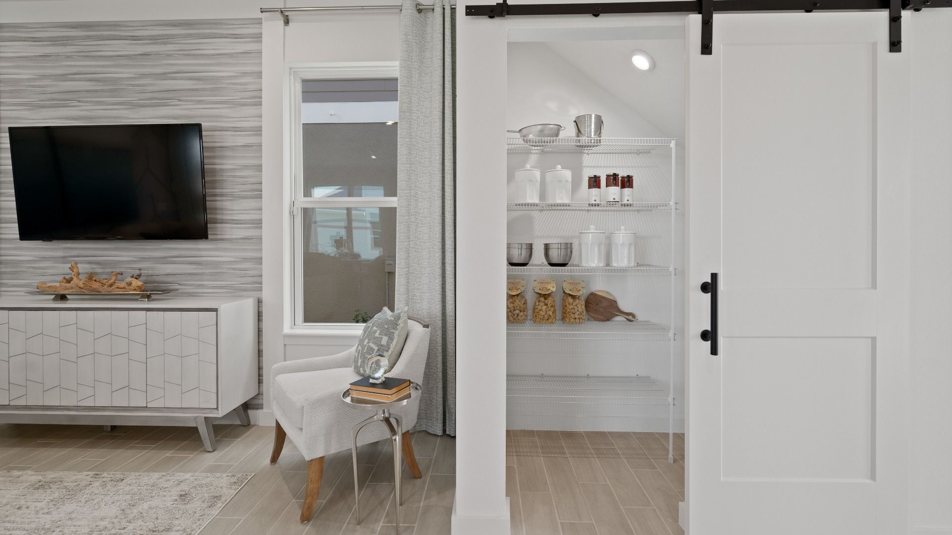 Kitchen pantry with barndoor at a DRB Homes Ambersweet model at the Trinity Place community.