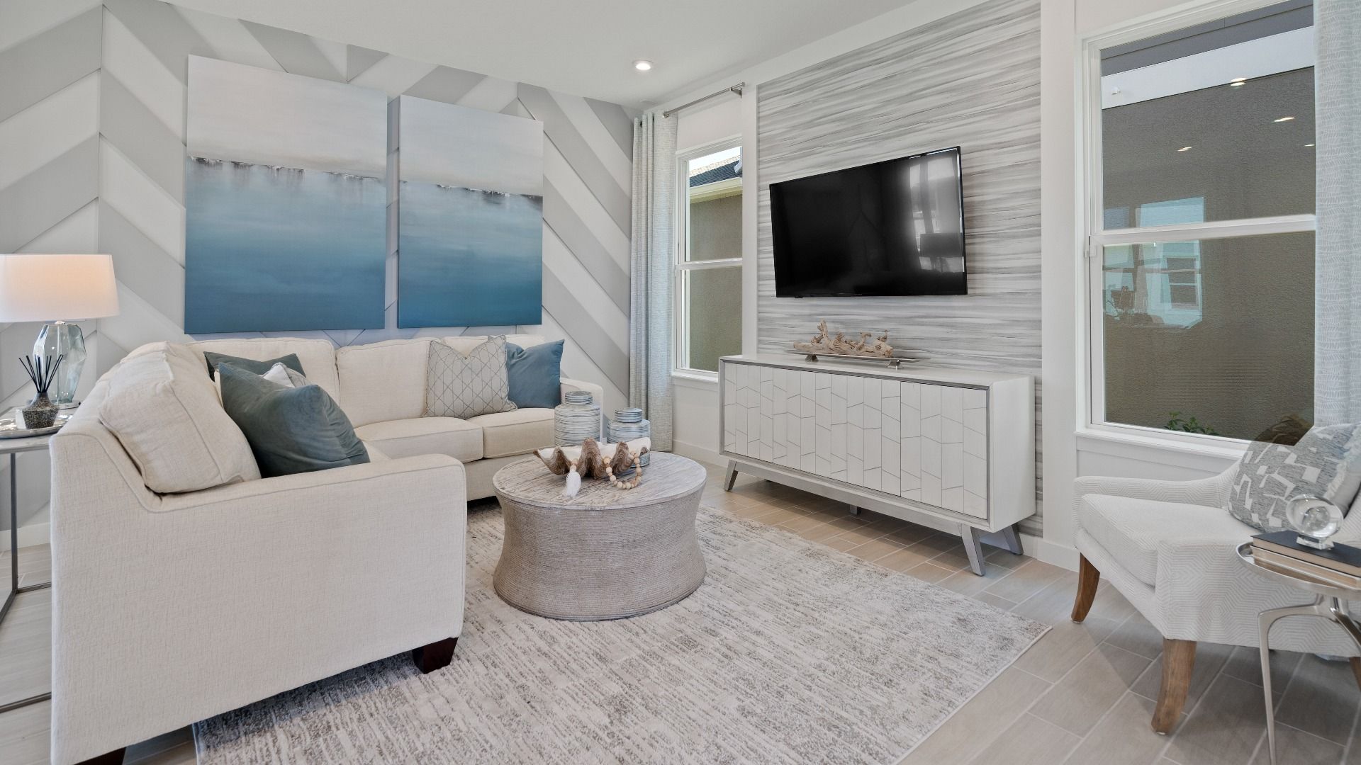 Family room with 2 large windows at a DRB Homes Ambersweet model at the Trinity Place community.