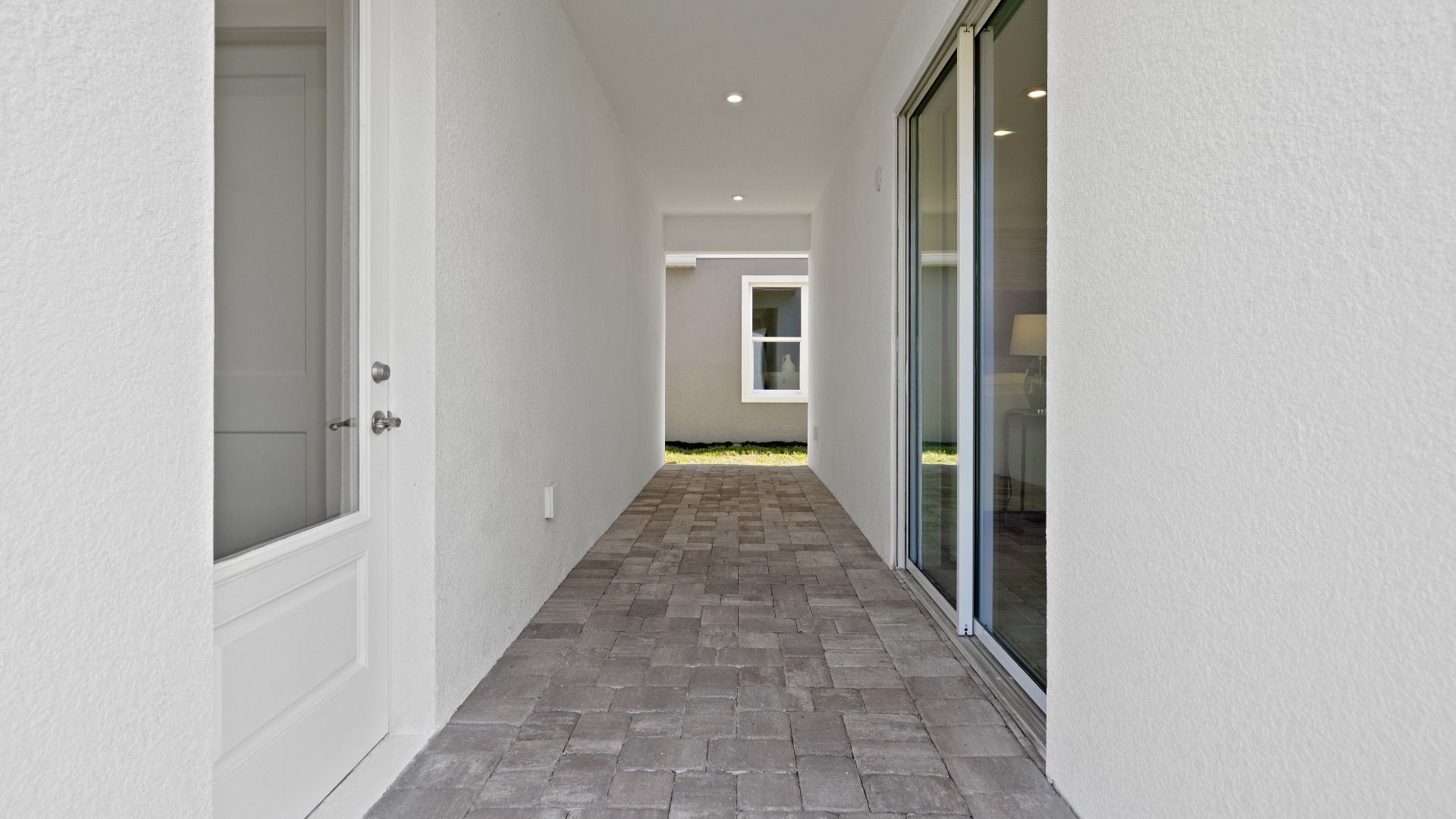 Outdoor lanai with access to garage and breakfast area in a DRB Homes Ambersweet model at Trinity Place.
