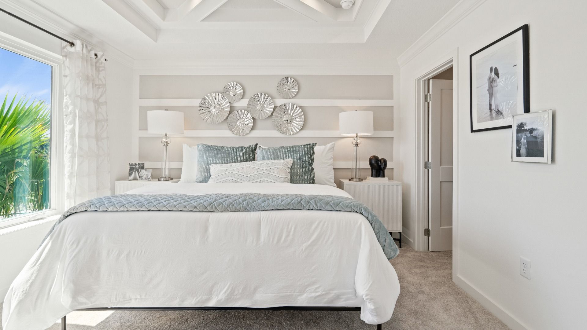 Primary suite with large double window and tray ceiling in a DRB Homes Ambersweet model at the Trinity Place community.