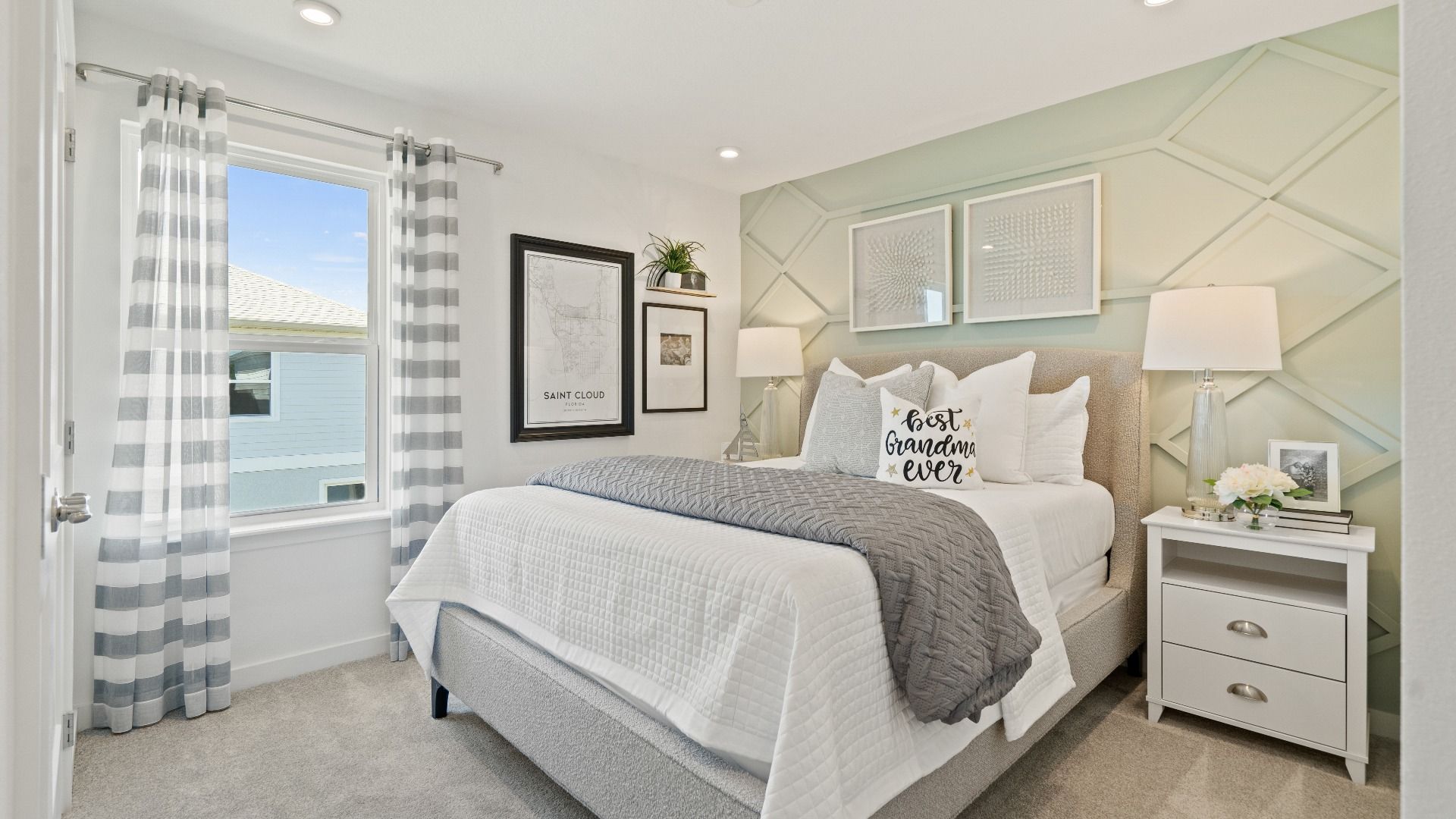 Carpeted secondary bedroom with large window in a DRB Homes Ambersweet model at the Trinity Place community.