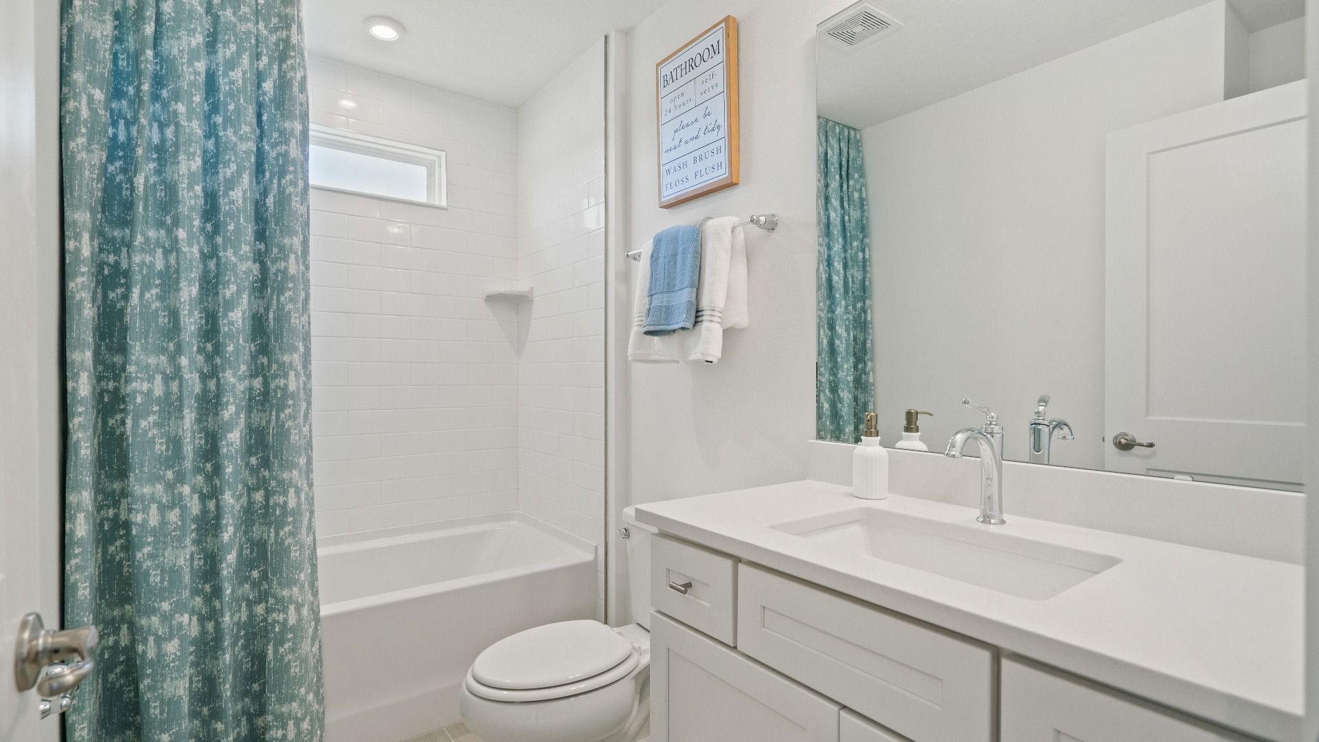 Full bathroom with shower/tub combo and clearstory window in a DRB Homes Ambersweet model at the Trinity Place community.
